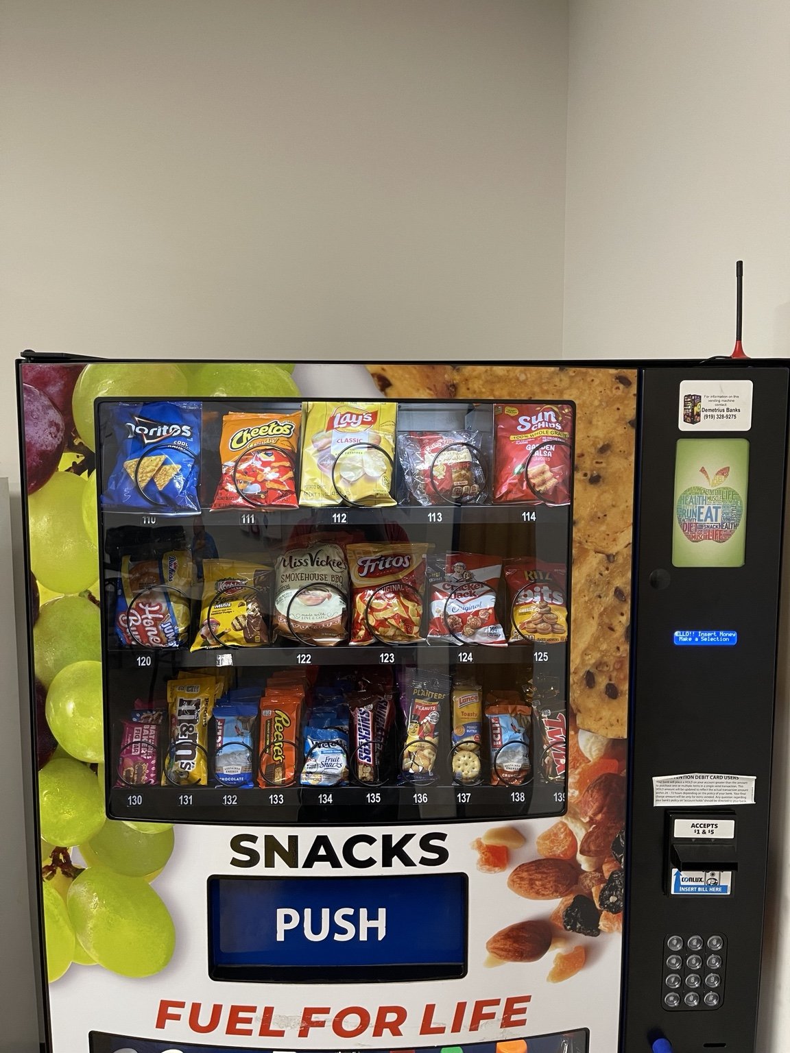 Vending machine snack selection with chips, candy, crackers, and popular grab-and-go items.