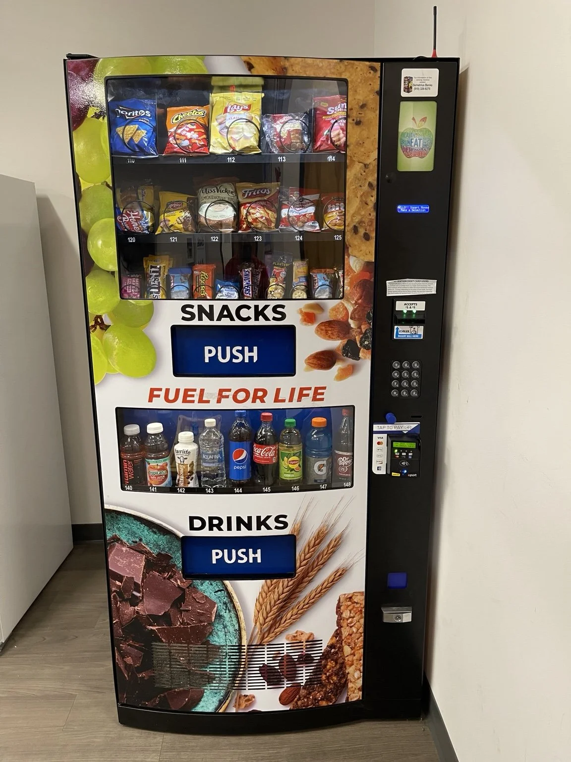 Workplace vending machine stocked with snacks, drinks, and convenient payment options in the Triangle area.