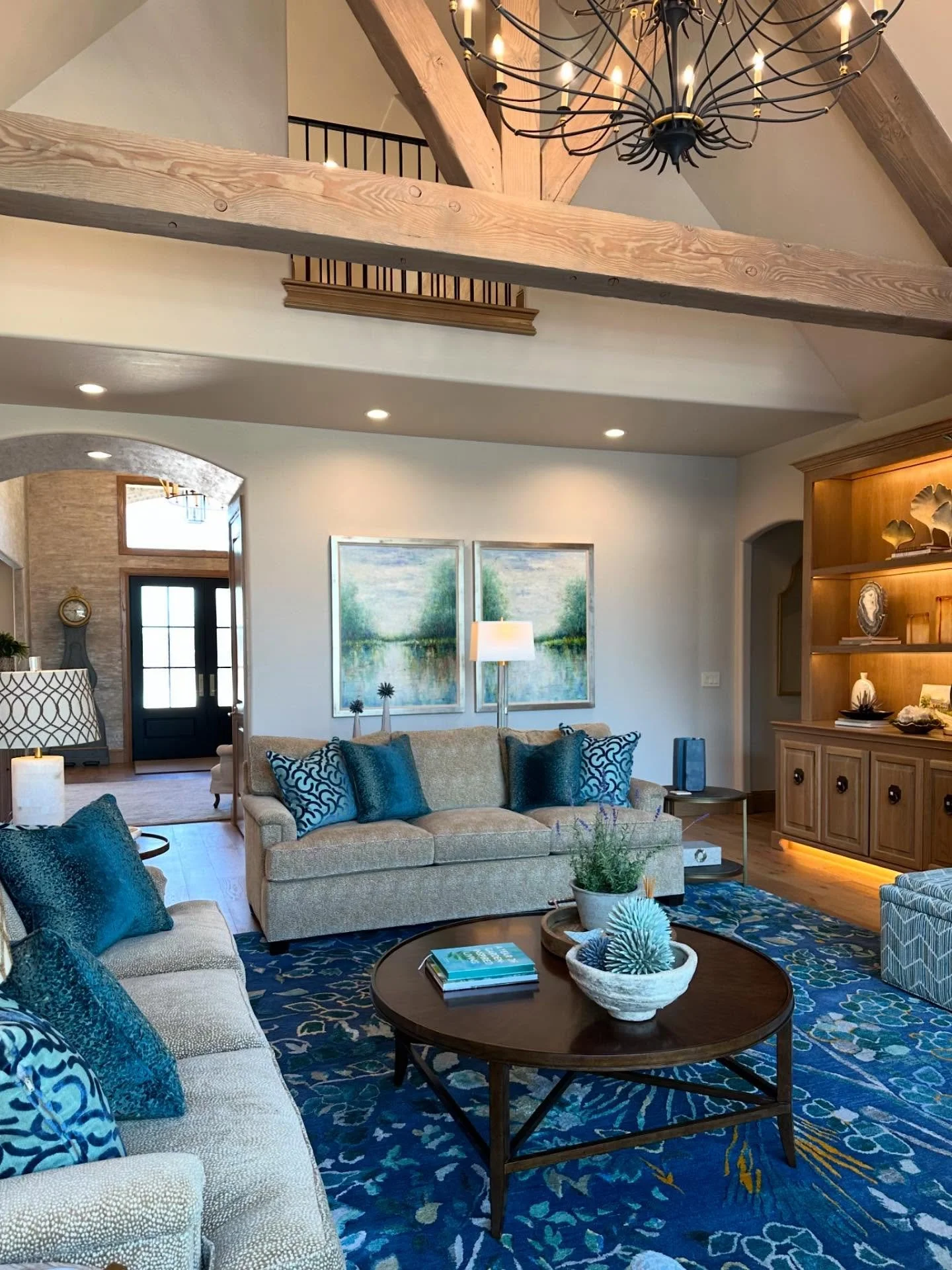 We worked closely with our clients&rsquo; wishes to create a vibrant and inviting ambiance in their tranquil living room. We began with the absolutely stunning rug in shades of blue and green which inspired the color palette. Natural elements and met