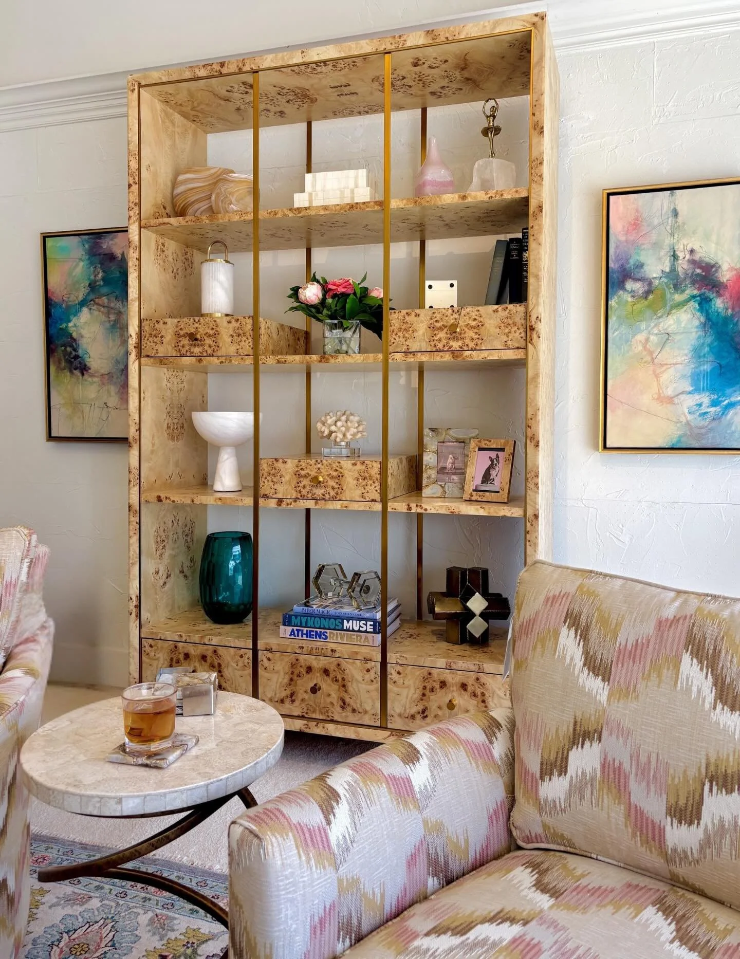 A new, fresh way to display! This bookcase features open shelves with decorative brass details, three lower stationary drawers, and three movable drawers for extra customization. Books, art, or any loved possession will shine from its burl wood shelv