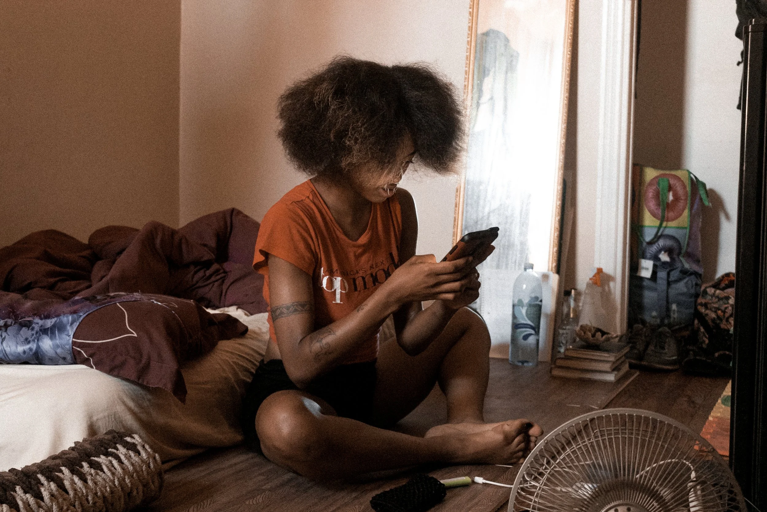 Opening her hips while on her phone.