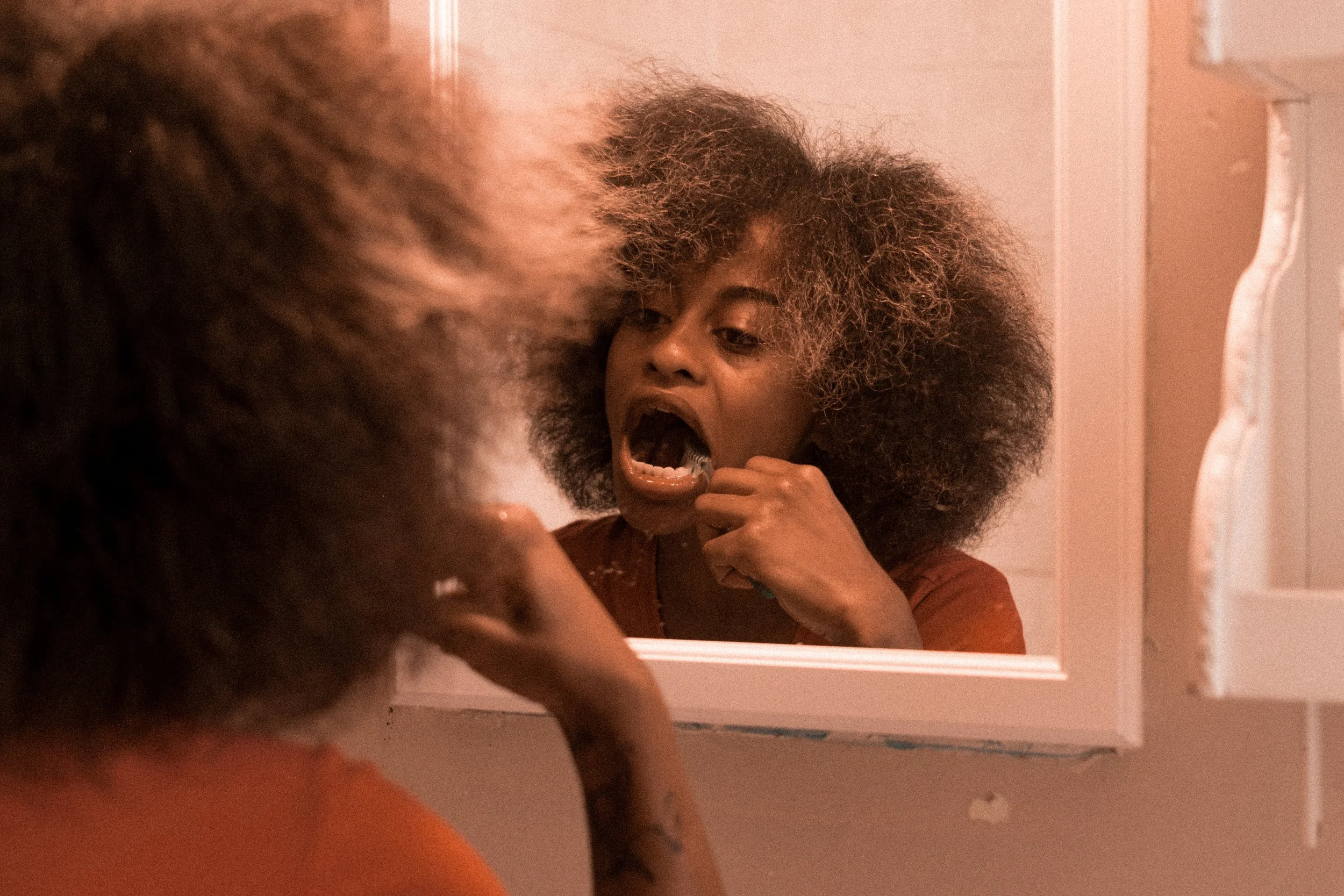 Another shot of brushing her teeth.