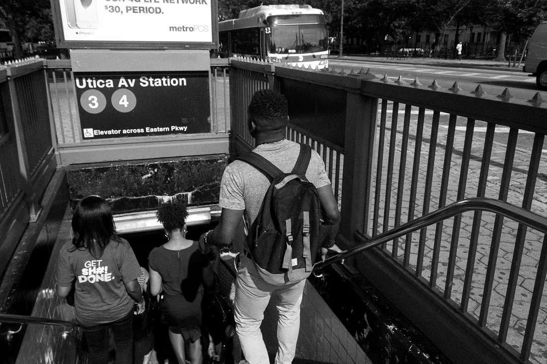 Descending the stairs of an MTA station.