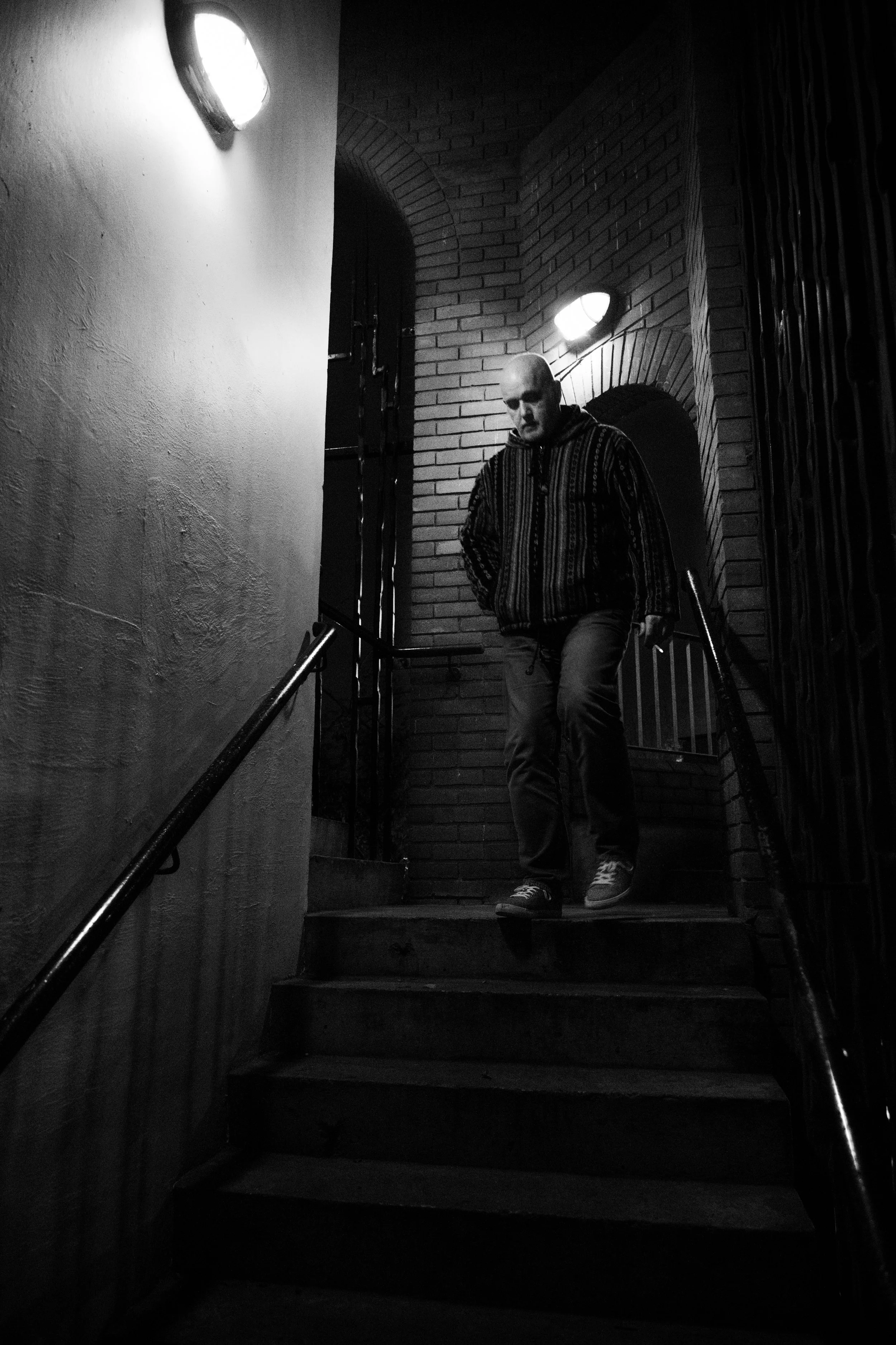 Bald Man walks down stairs.jpg