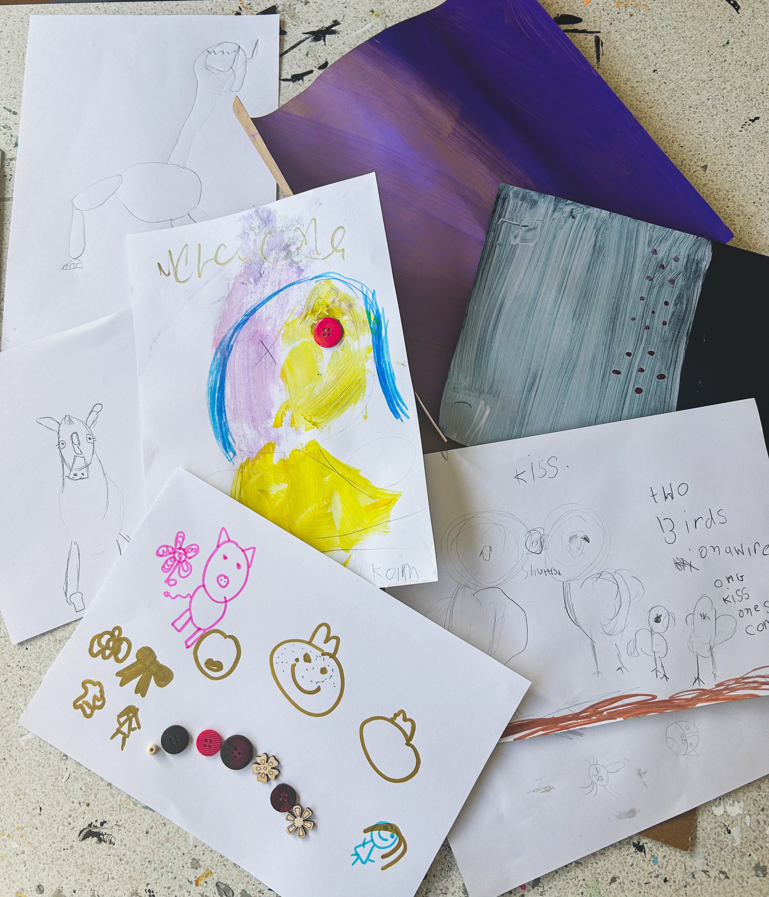 A collection of children's drawings and paintings, including animal sketches, colorful portraits, and handwritten notes.