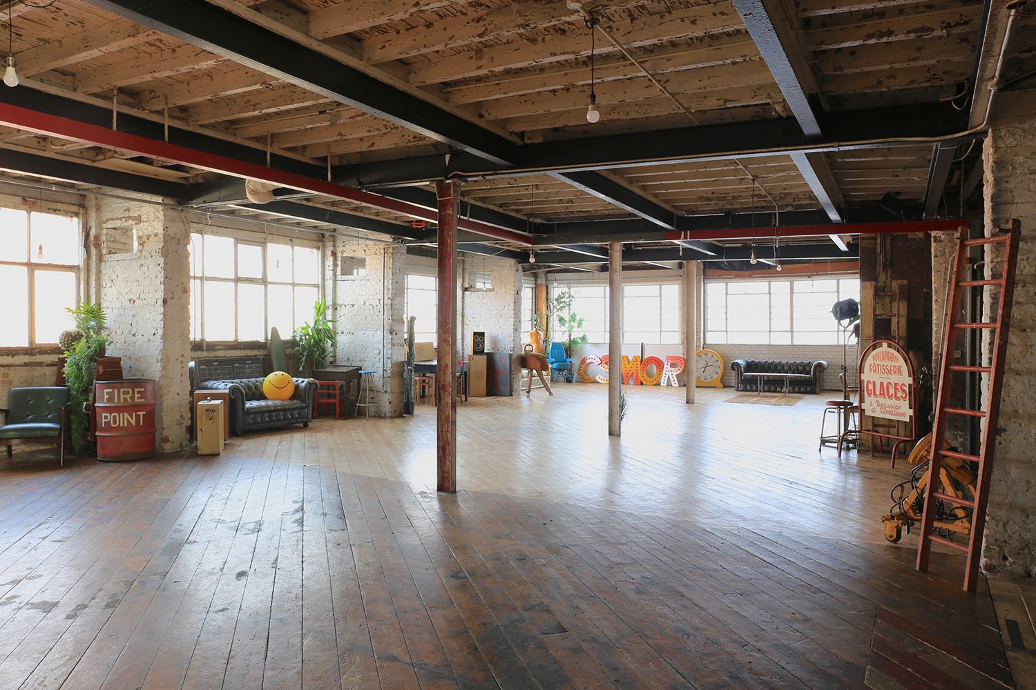 Distressed warehouse studio interior with vintage furniture and props, located in east london