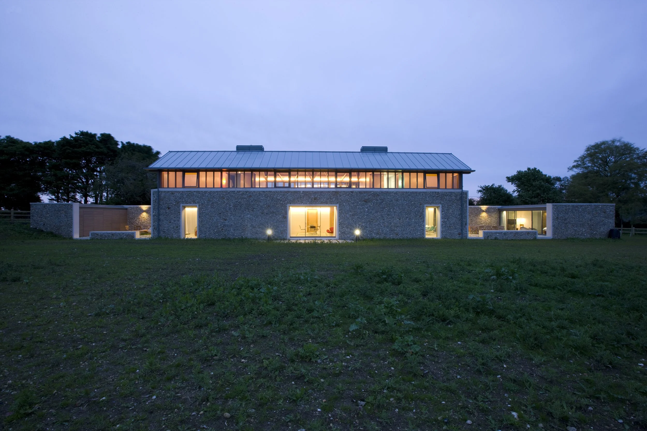 Exterior shot of large flint stoned house offering clean architectural lines and strong light for exterior shoots