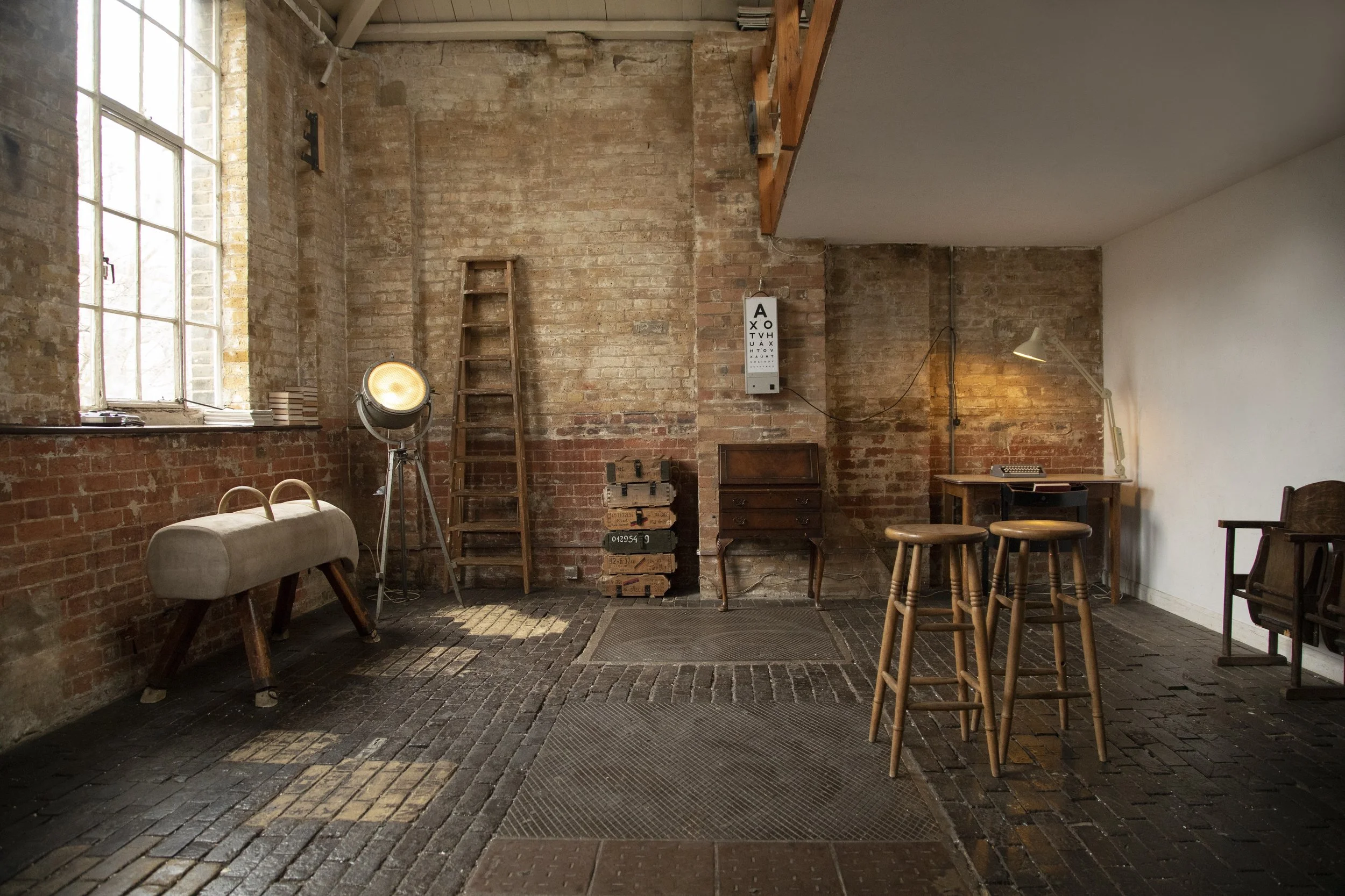 Warehouse photography studio, with stone floor, exposed brick and vintage props, Located in East London