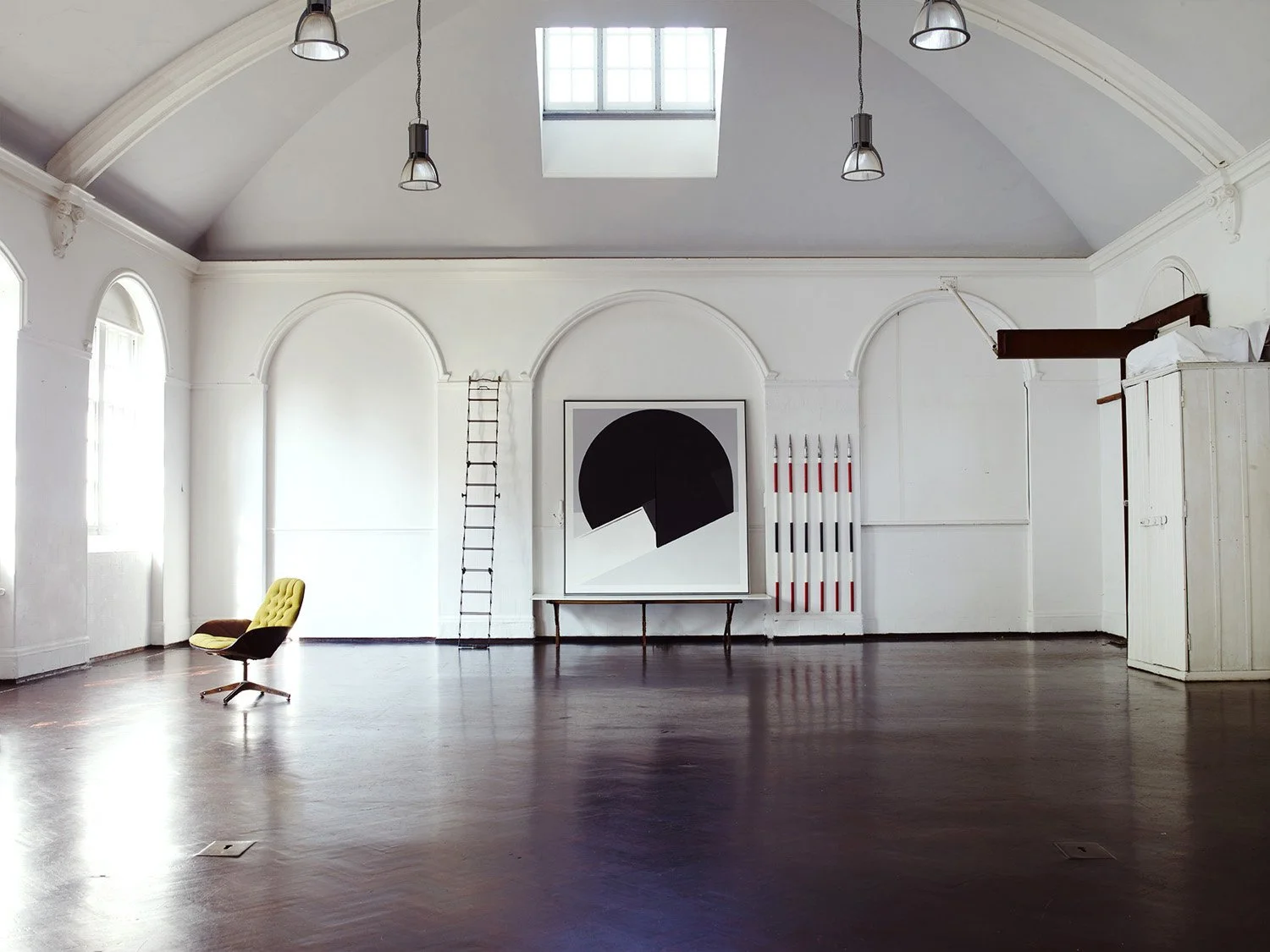 Vintage photography studio with white walls, victorian features and dark wooden floor, East London