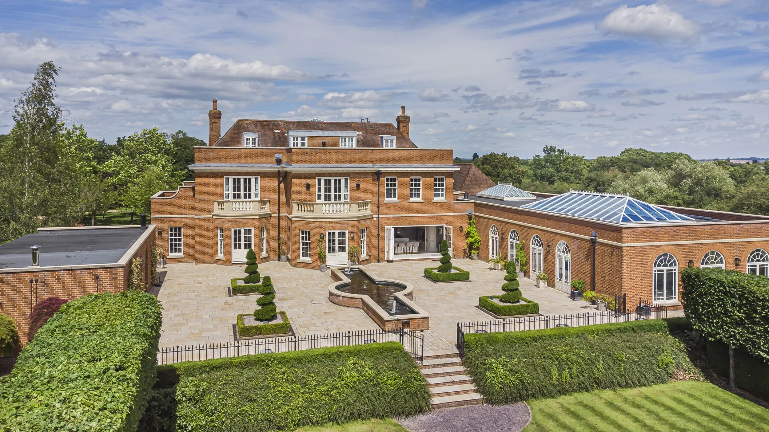 Exterior view of a red brick Regency house and Gardens located in Hertfordshire