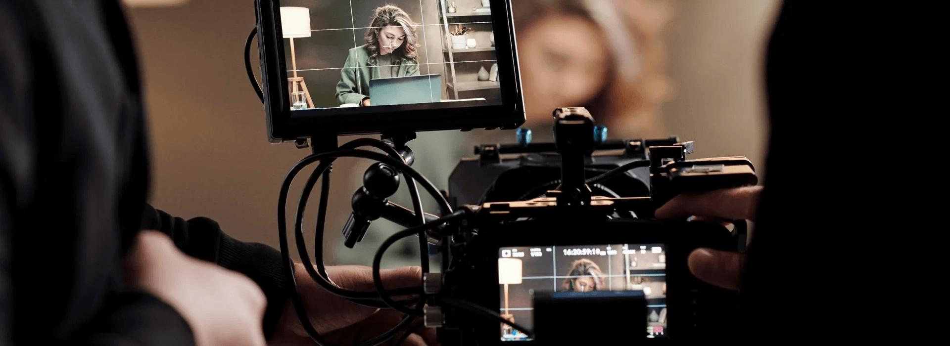 Camera monitor filming a business video shoot with subject in frame