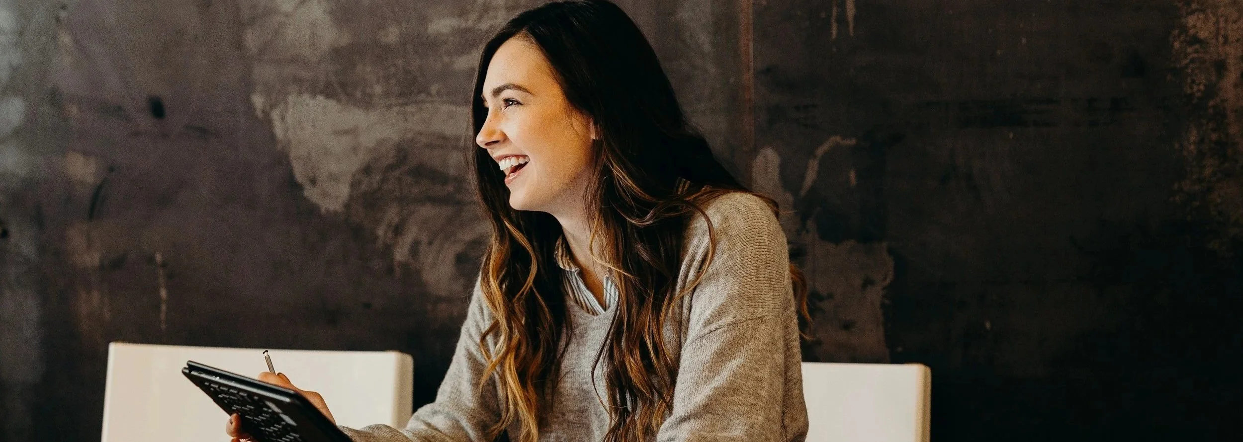 Interview subject smiling during a relaxed testimonial video conversation
