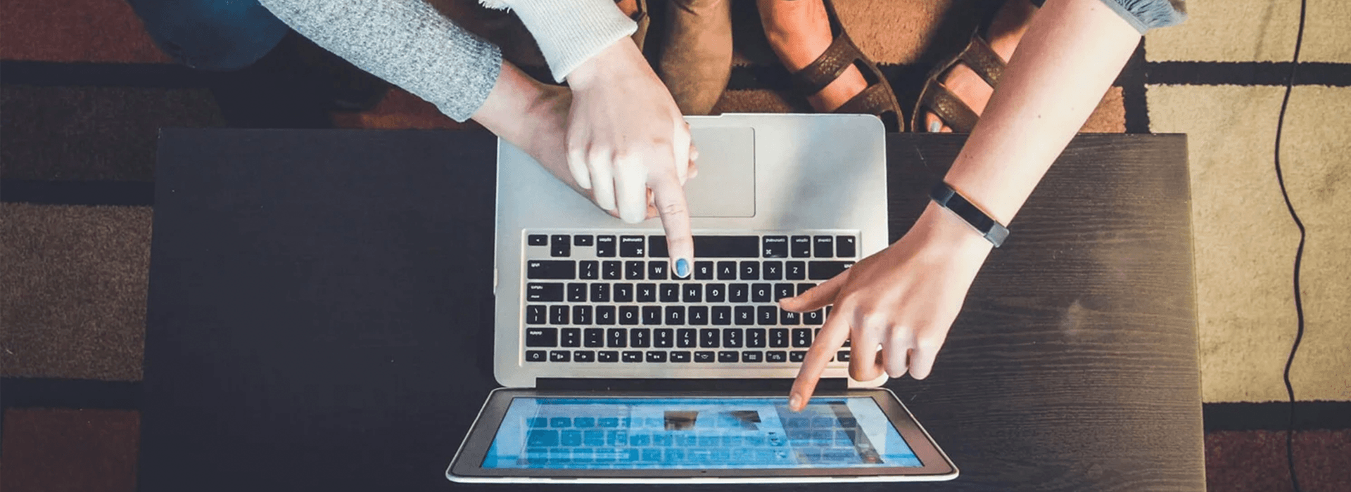 Team reviewing video analytics and content performance on laptop and table