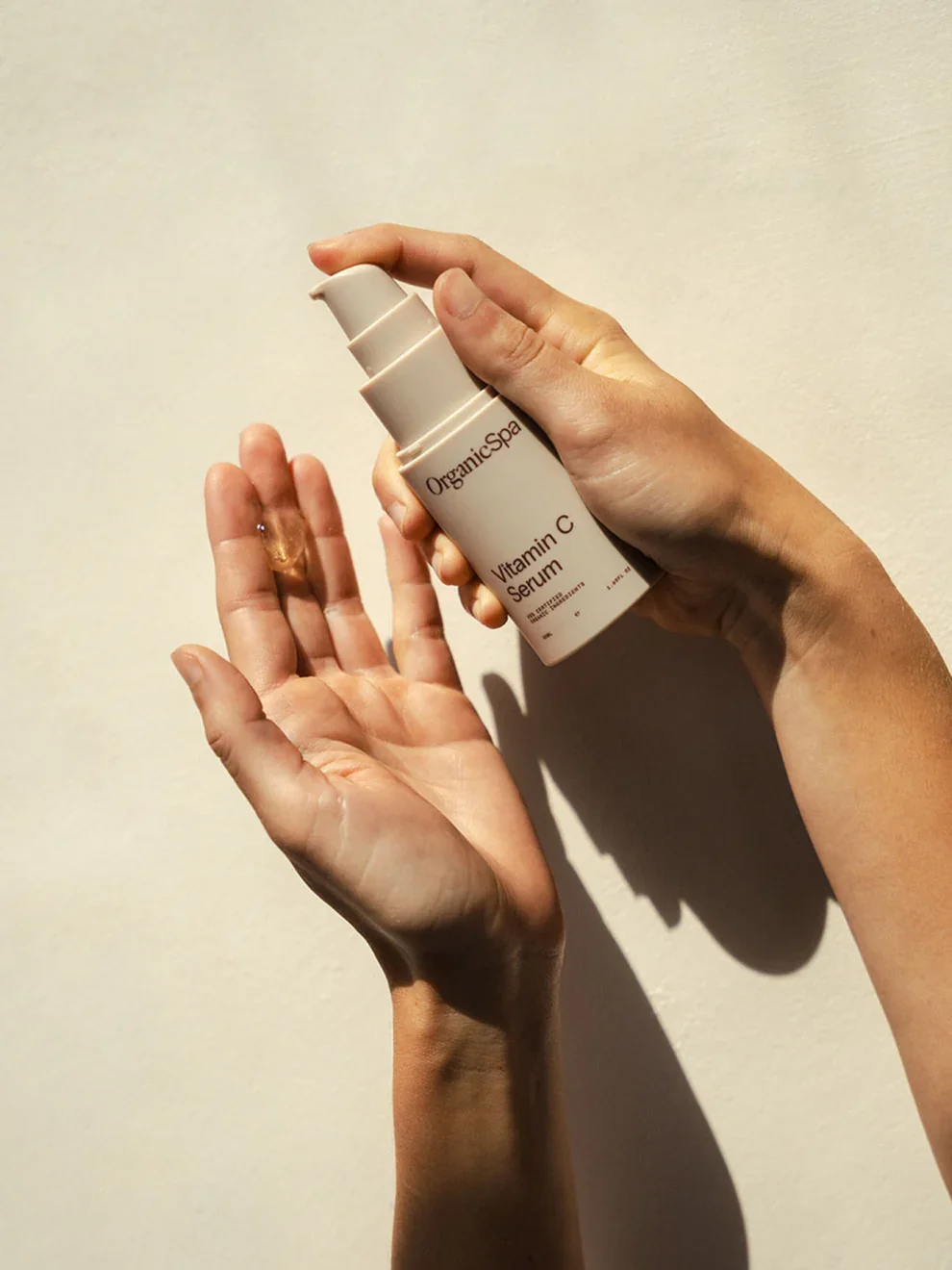 organicspa-vitamin-c-serum-face-serum-certified-organic-skincare-australia-in-use-hands-sunlight.webp