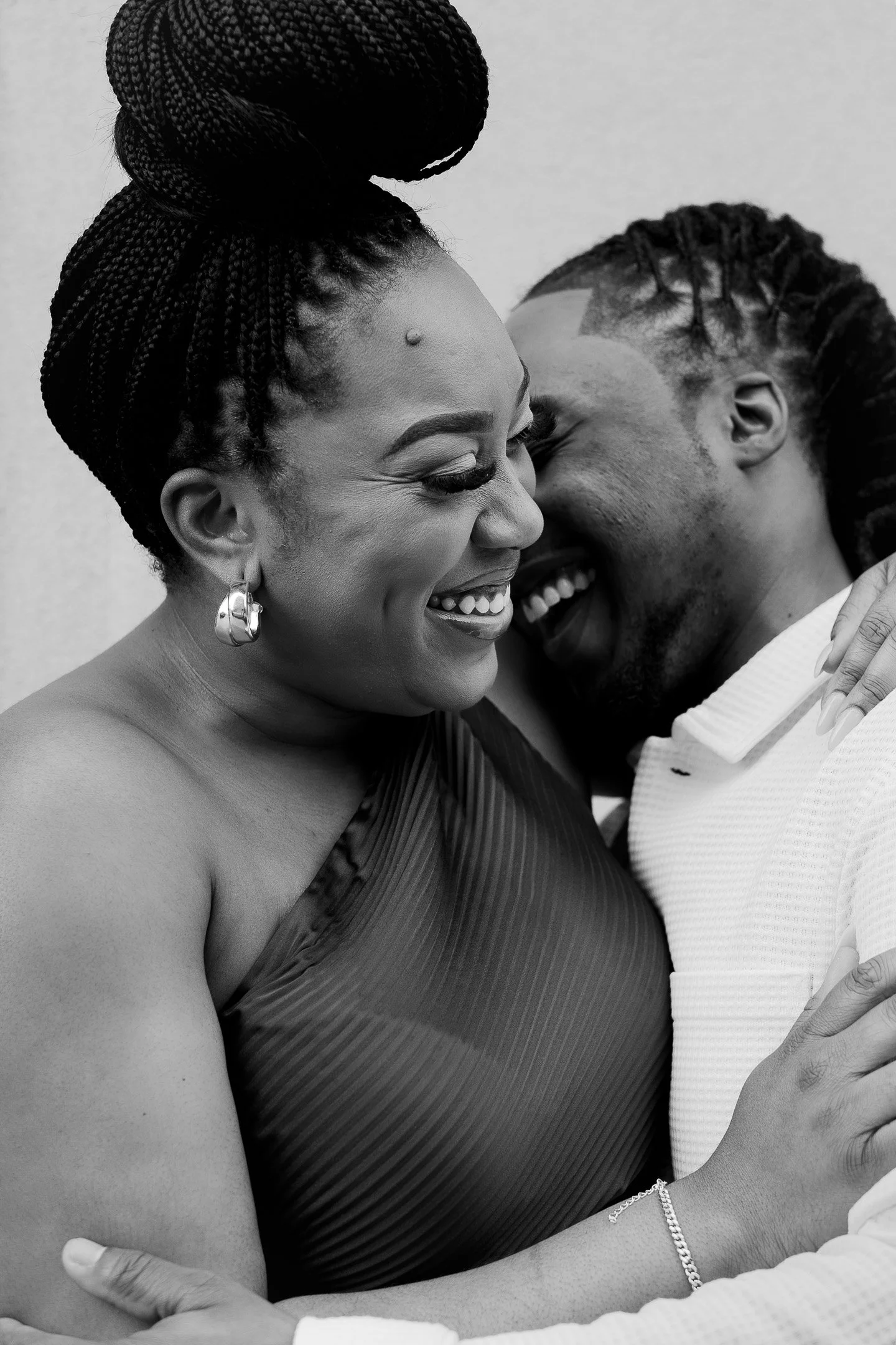 Black and white photo of a couple embracing and smiling
