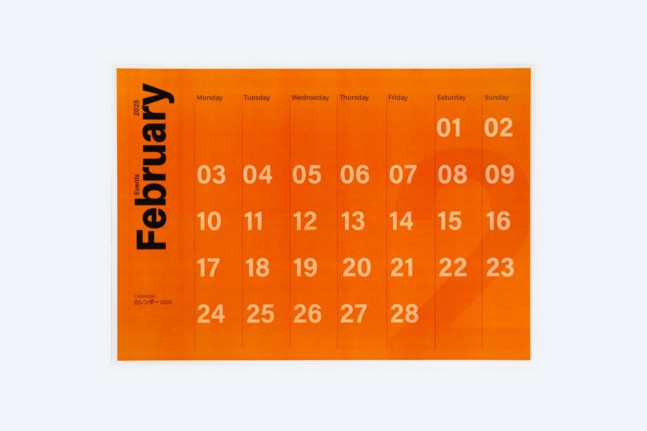 An orange wall calendar showing the month February 2018