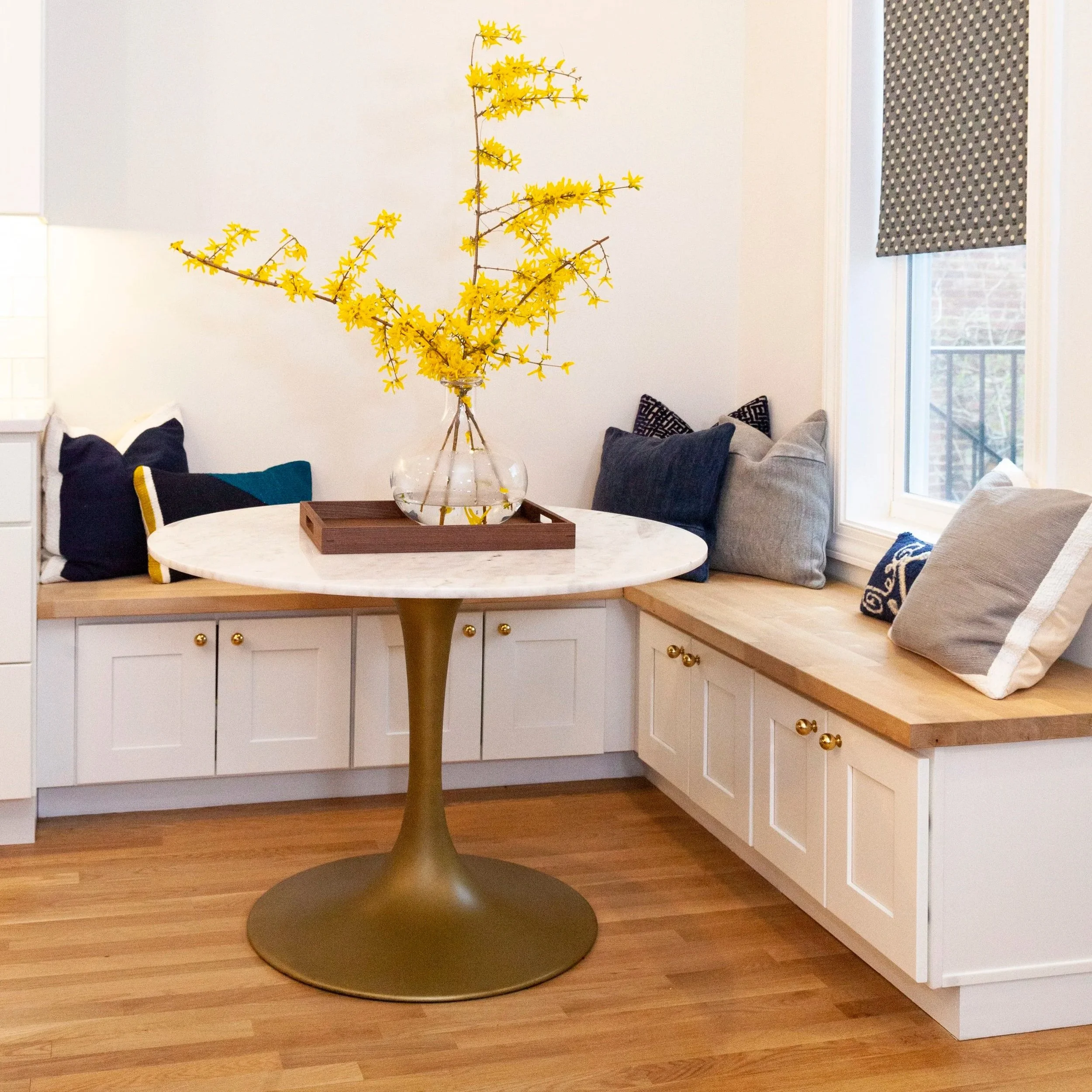 Navy kitchen island with walnut barstools and gold pendant lights, Washington DC interior designer