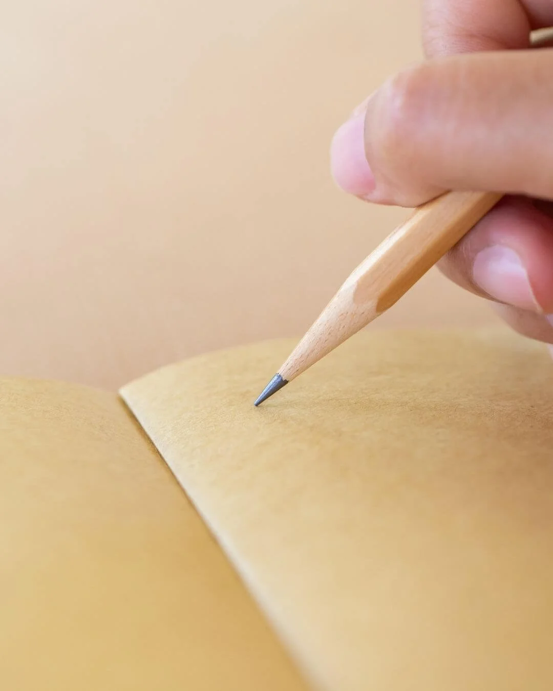 pencil writing in notebook