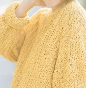 yellow jumper close-up representing imperfect knitting