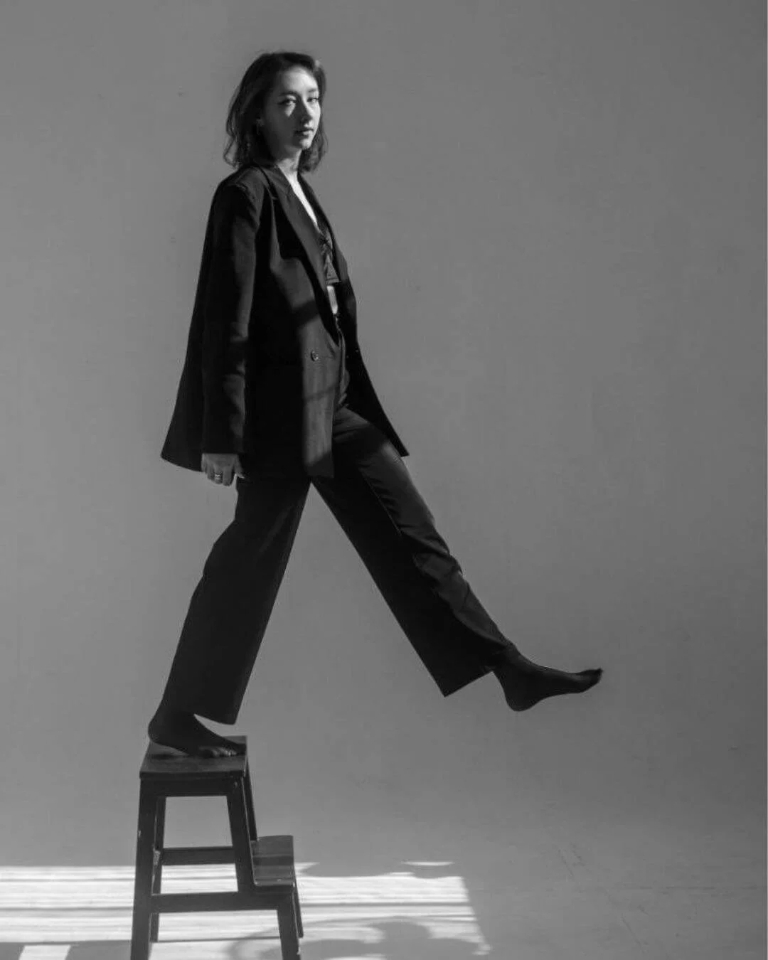woman stepping off stool representing a silly walk
