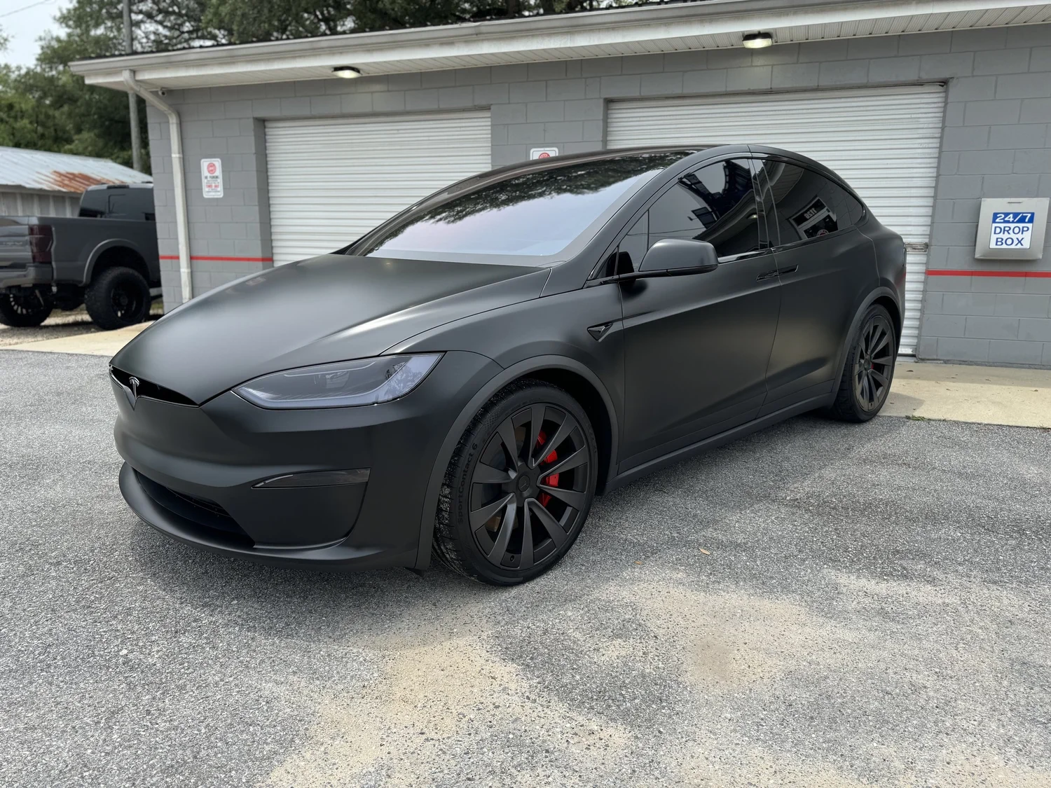 Black Tesla Model S outside the OCD shop