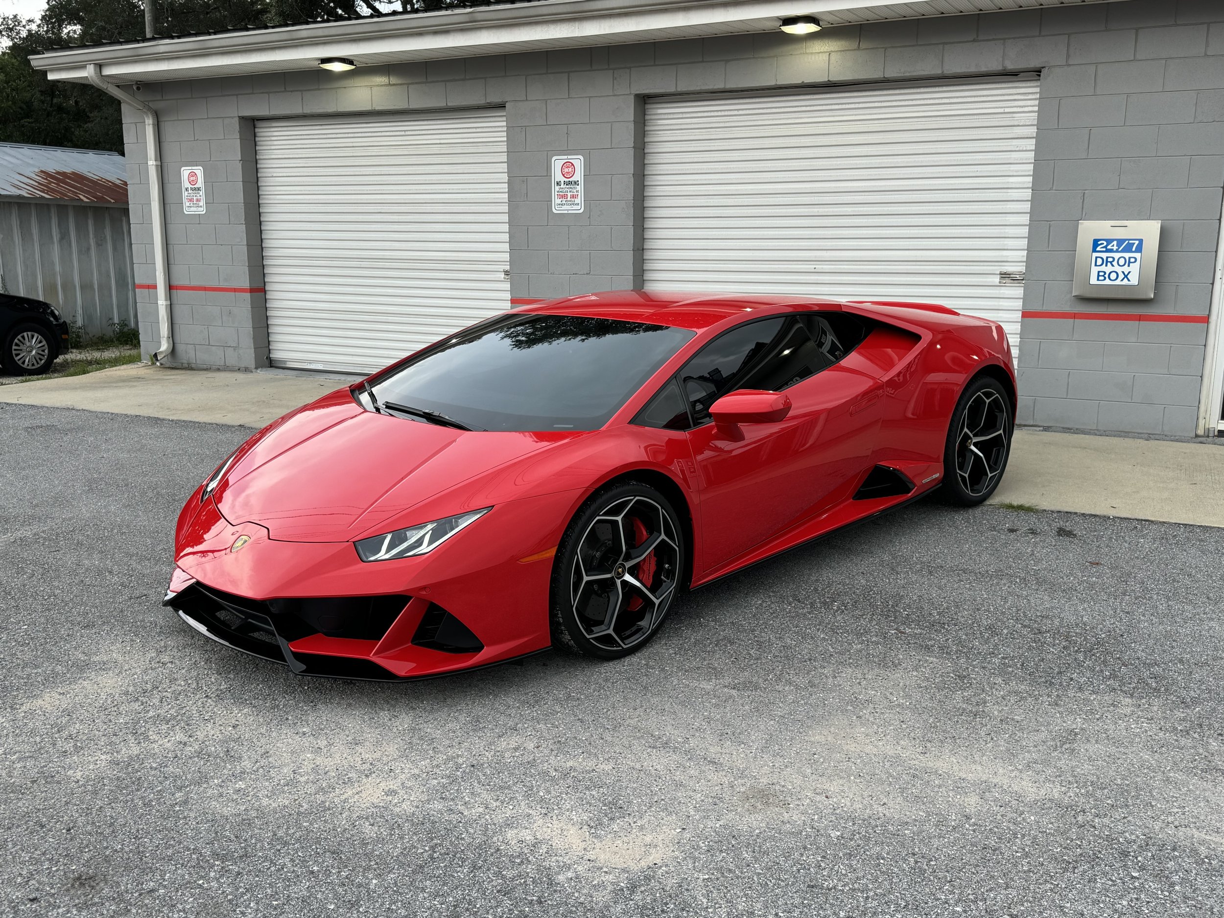 Close-up of a yellow sports car's side window with the text 'WINDOW TINTING' overlayed.
