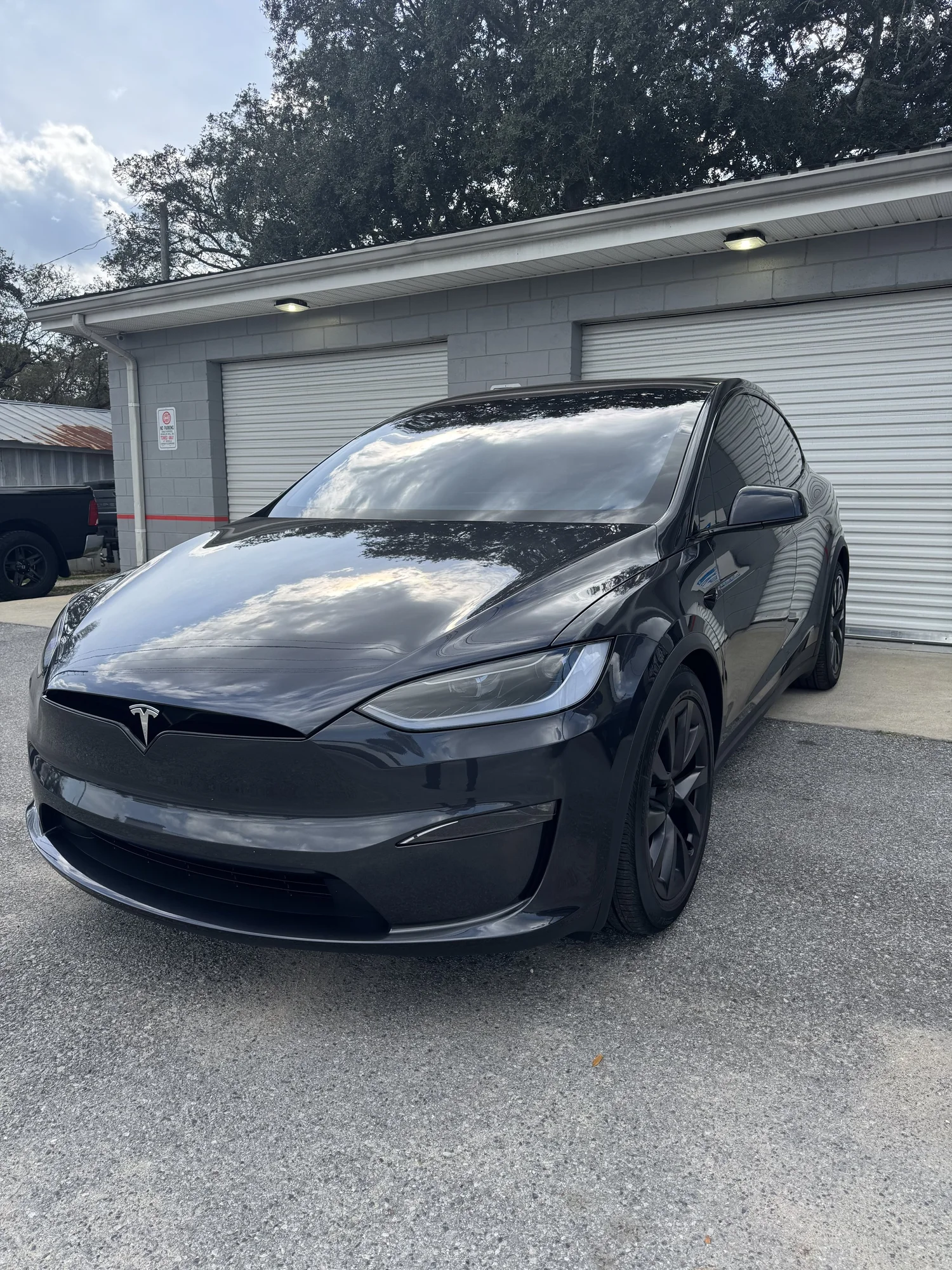 Black Tesla Model X outside the OCD shop in Fort Walton Beach.