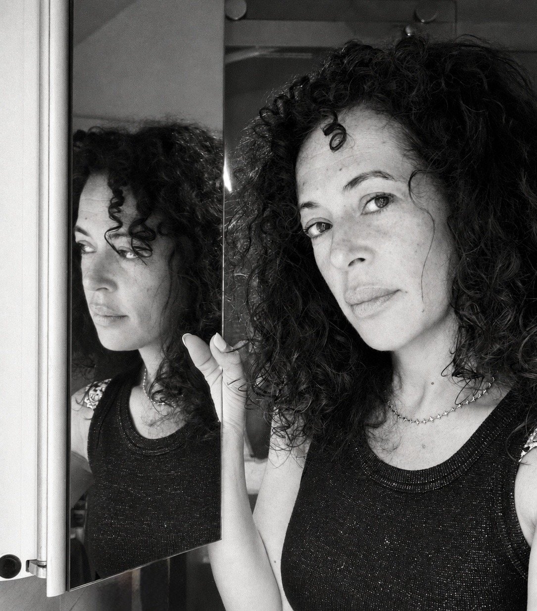 Mala Moonbeam beside her reflection in a quiet Mirror Time Method moment