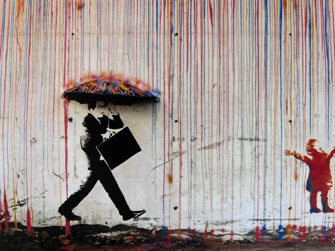 Banksy picture; man walking with umbrella under colors pouring down. Child off to the side.