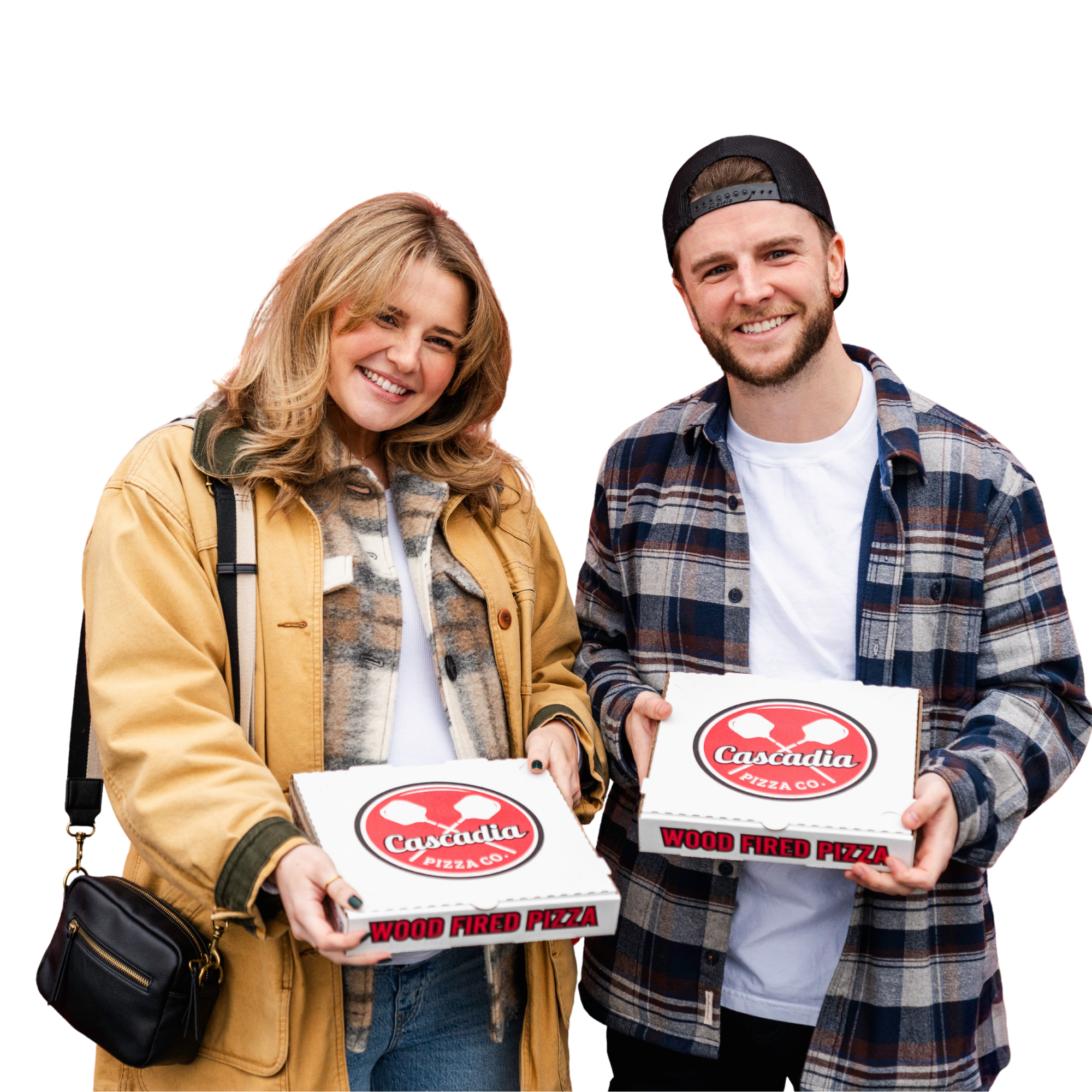 A smiling man and woman holding pizza boxes from Cascadia Pizza Co. at an outdoor event.