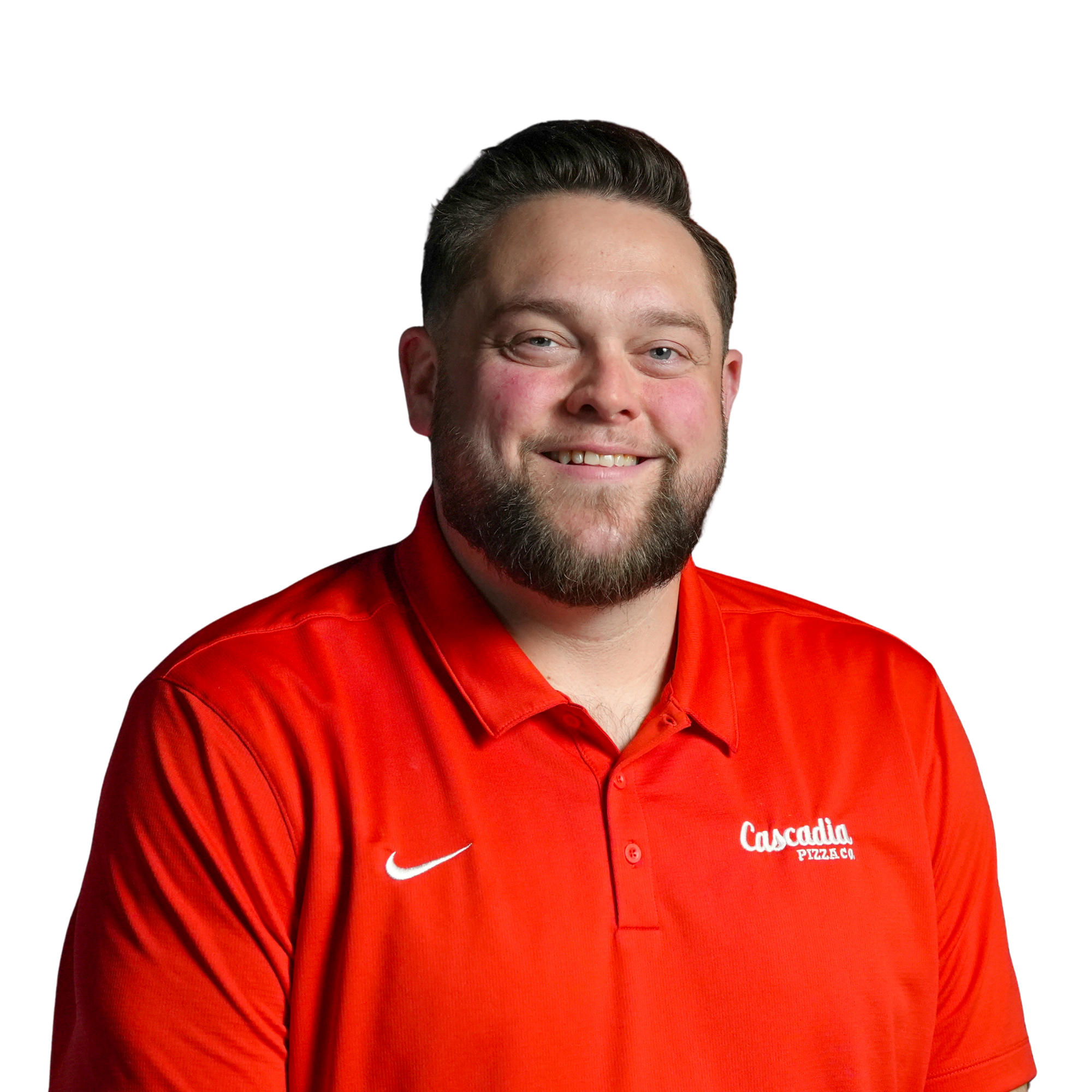 Close-up of a smiling man with a beard wearing a red collared shirt with a Nike logo and Pizza G logo, against a black background.