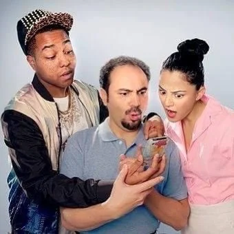 Three people, two women and one man, looking at a phone with surprised and curious expressions.