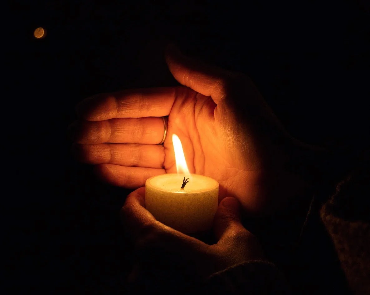 A hand holding a candle