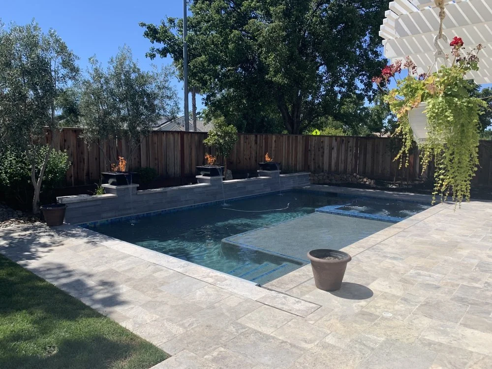 pool an spa with water fire bowls