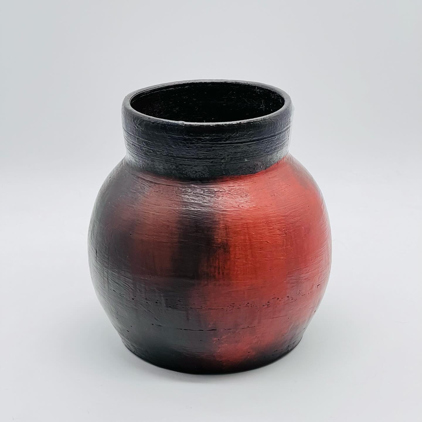 A smoked Raku piece with red slip. This was my first time doing Raku back in 2021, and I was hooked. I love the different shades from deep red to a smokey black on this piece. I held on to this piece for a while and I just decided to let it go into t
