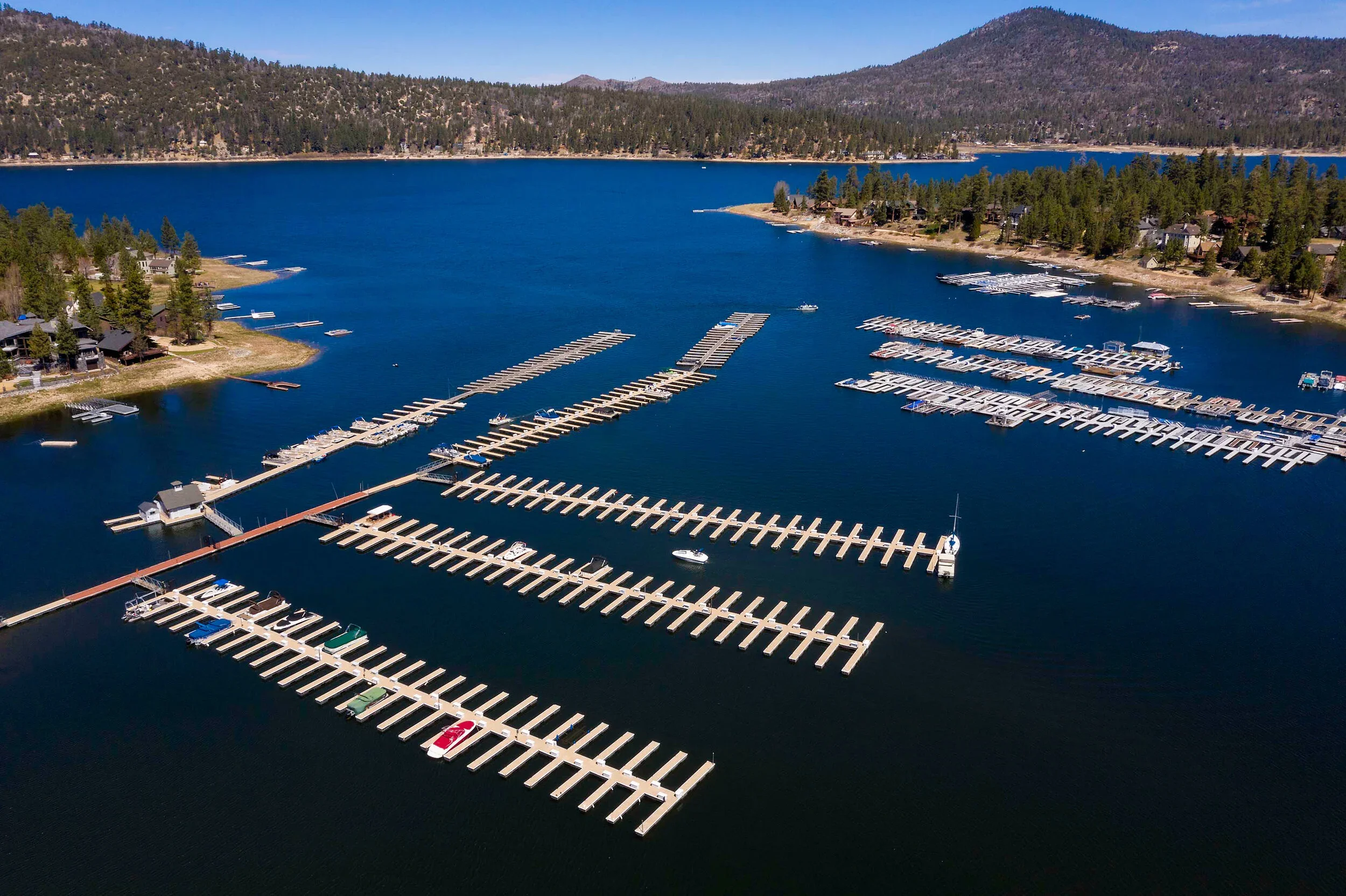 Pleasure Point Marina Docks set against the sapphire blue of Big Bear Lake with the mountains framing the lake