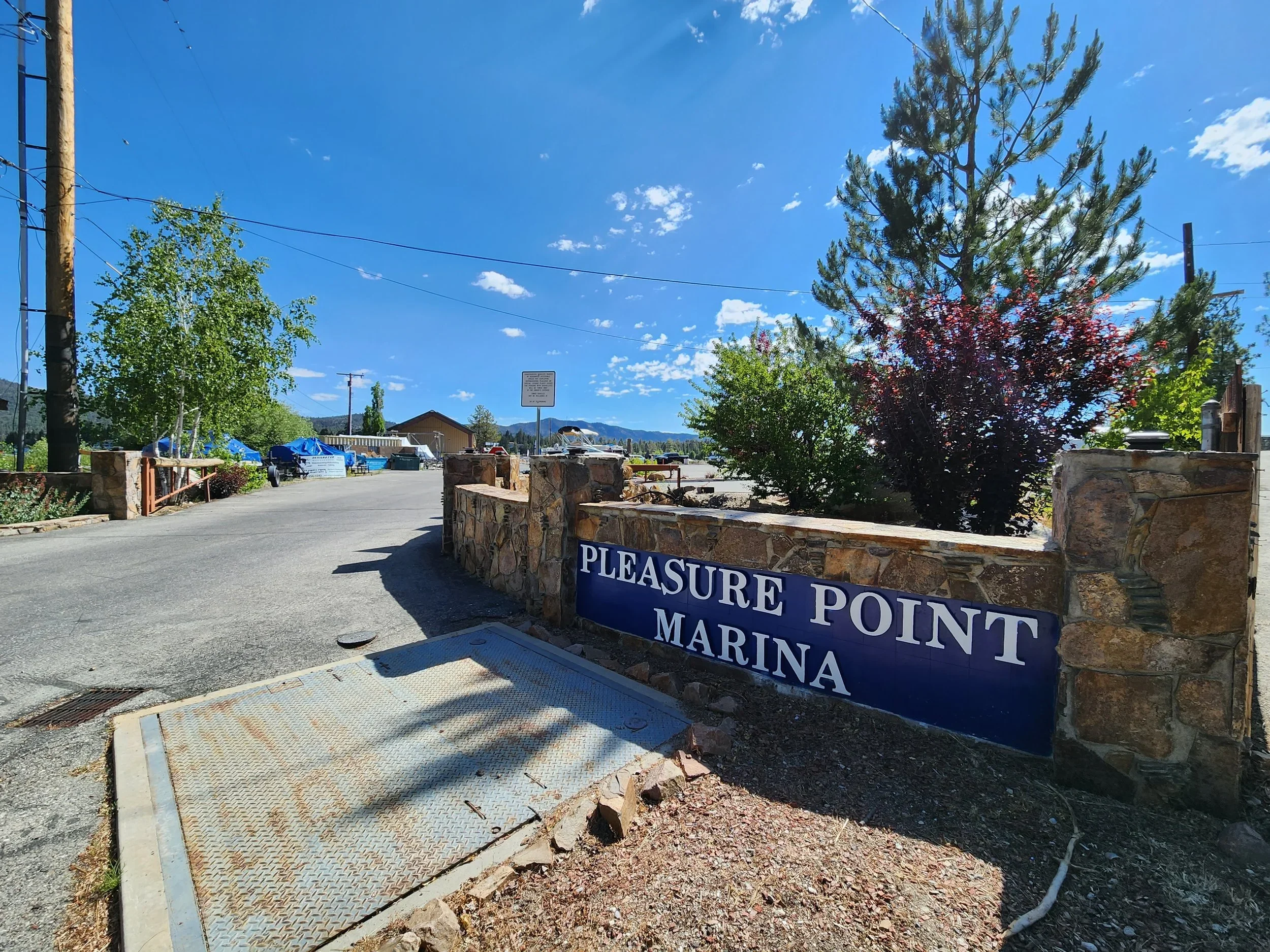 Pleasure Point Marina Entrance with an elegant stone wall surrounding their sign