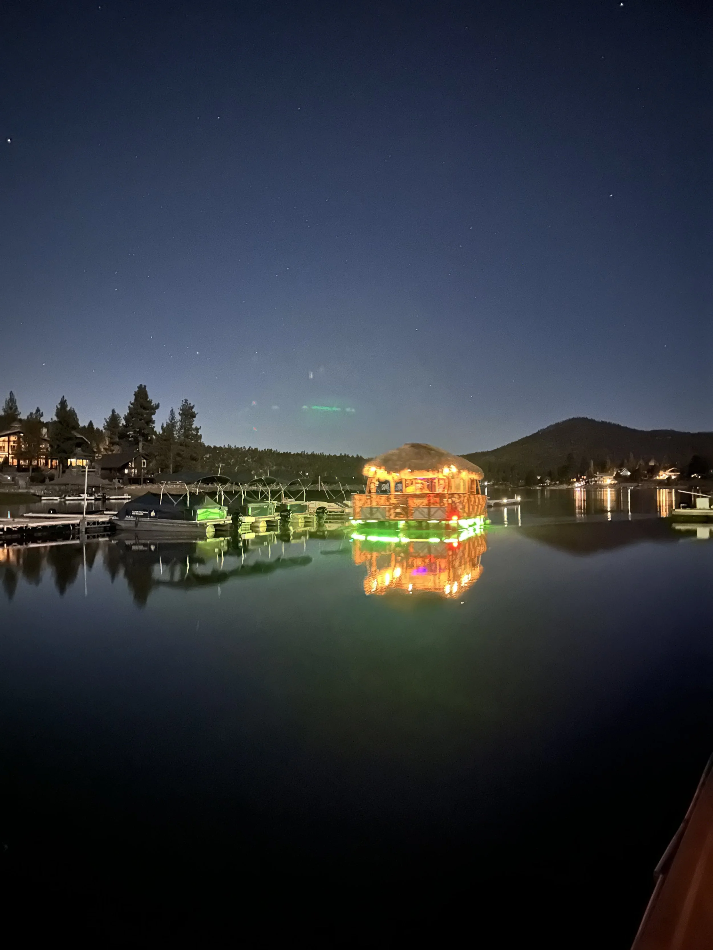 Big Bear Tiki Tours boat coming in to dock at Pleasure Point at night