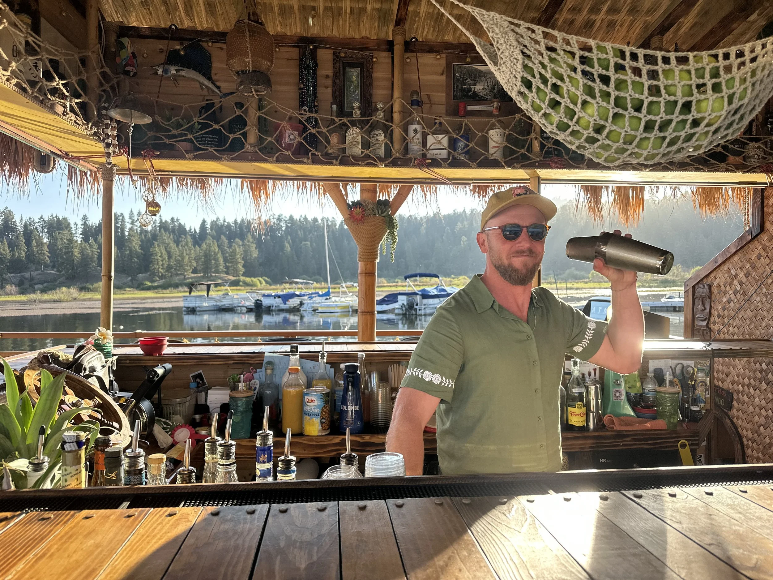 Captain Cocktail shaking up a cold one during golden hour on the Big Bear Lake Tour