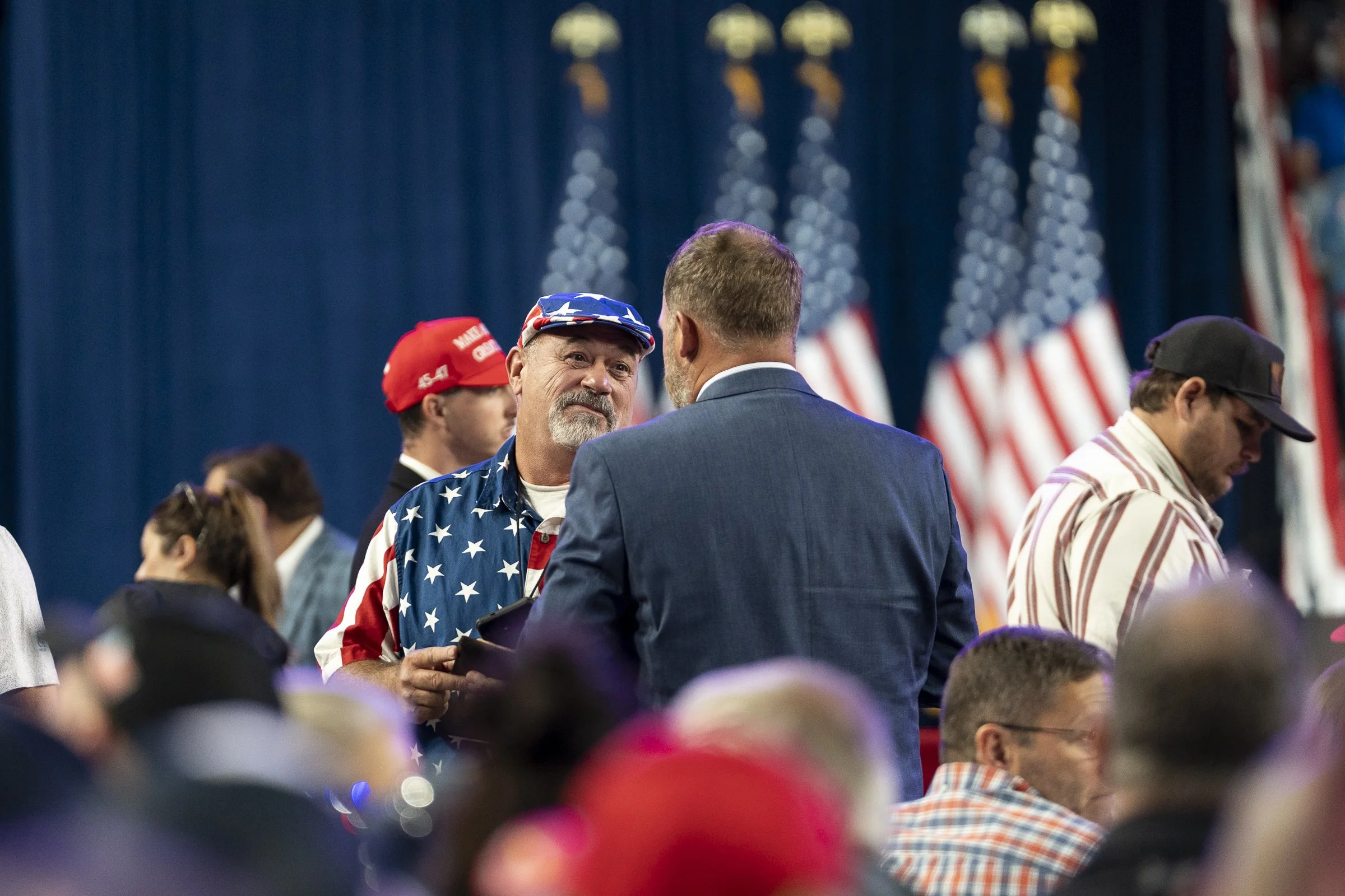  Attendees mingle between speakers and the appearance of President Trump. 