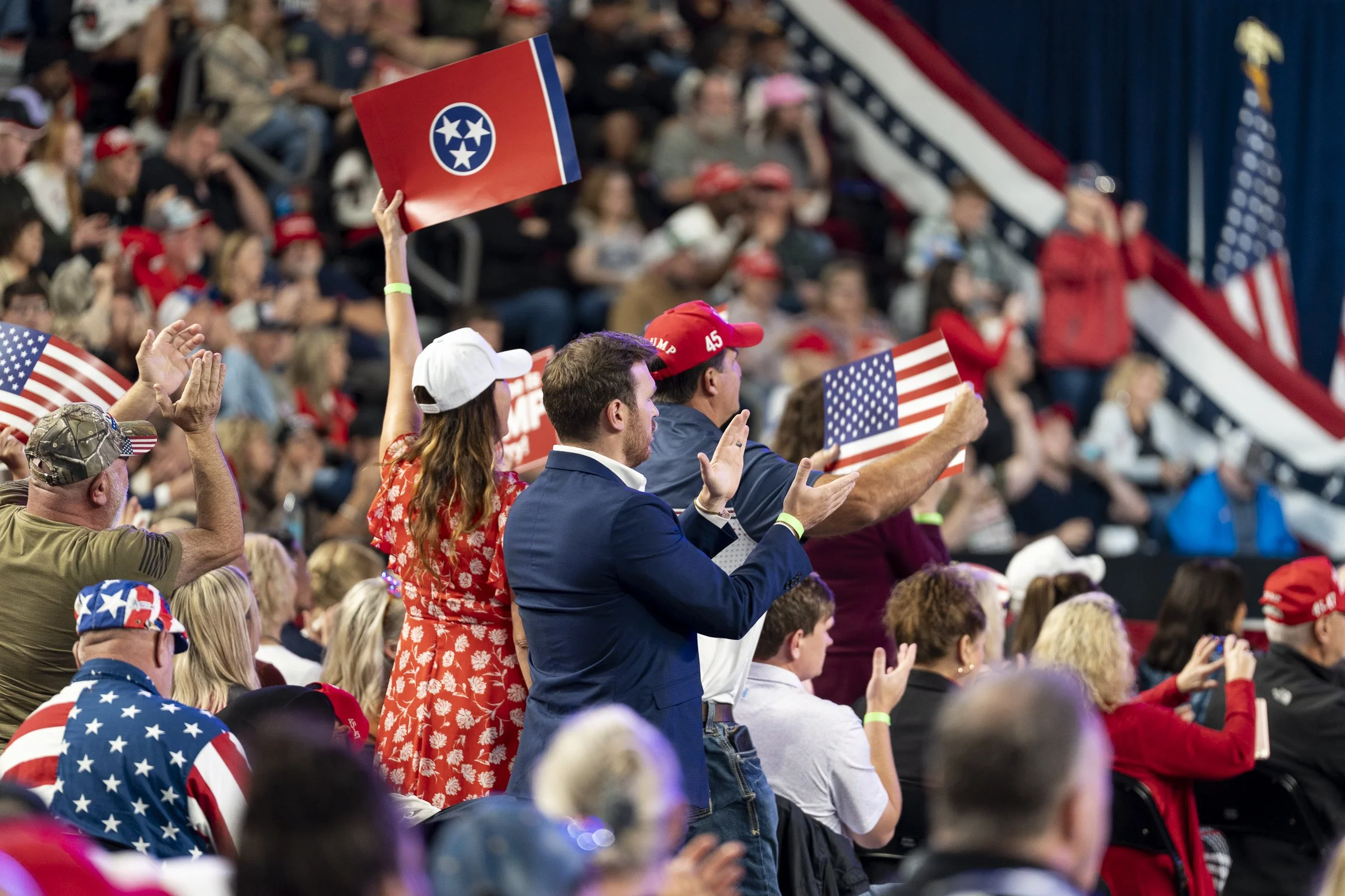  Guests cheer and hold up signs as speakers address the crowd.  