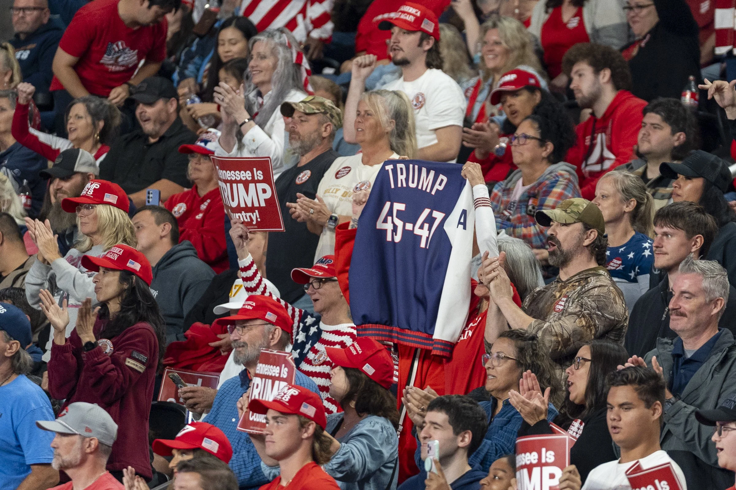  Attendee holds Trump jacket display his presidency numbers (45-47).  