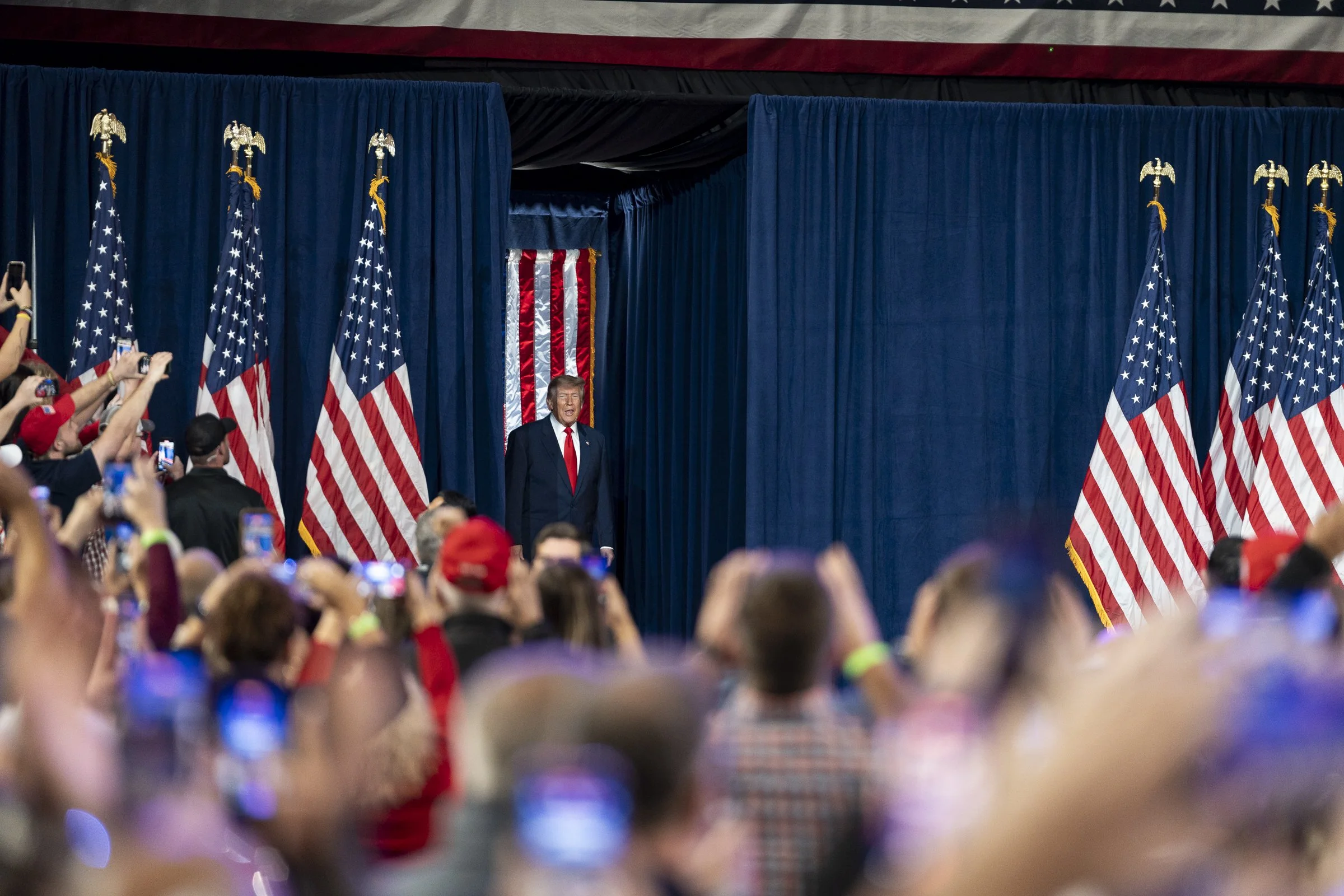  President Donald Trump enters the stage. 