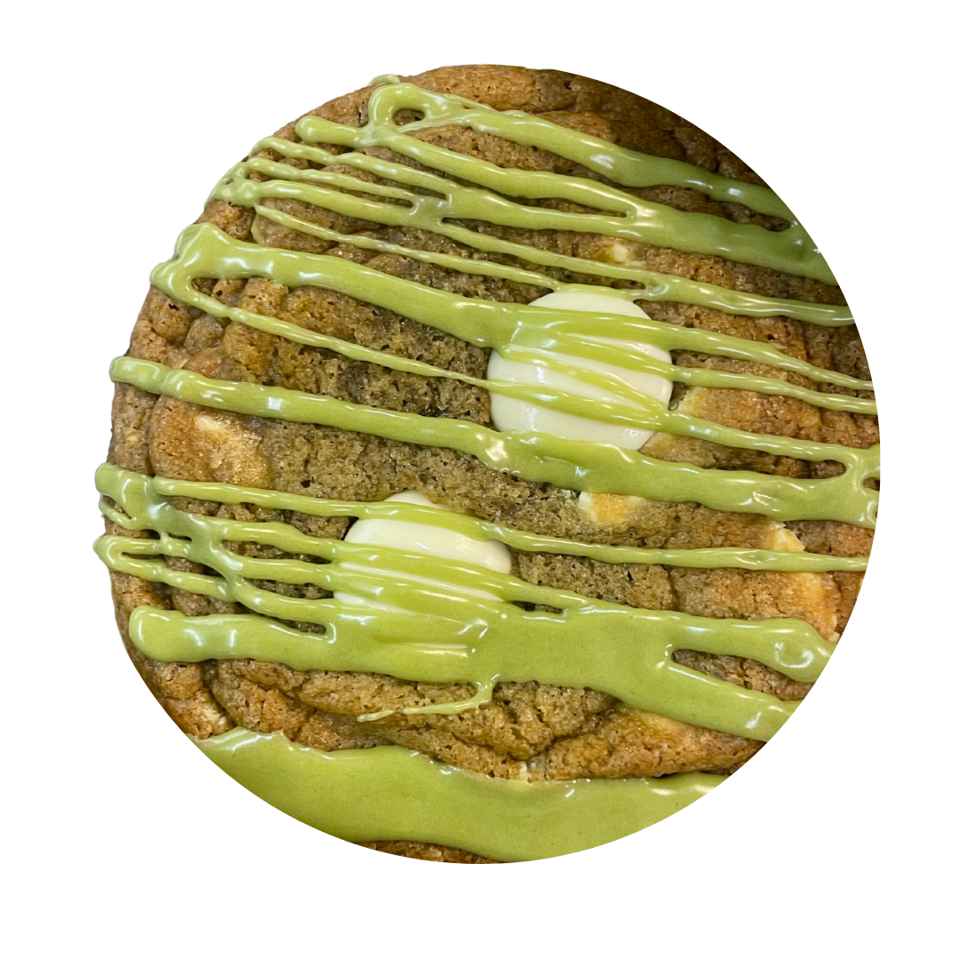 A cookie with white chocolate chips, colorful sprinkles, and white chocolate discs on top.