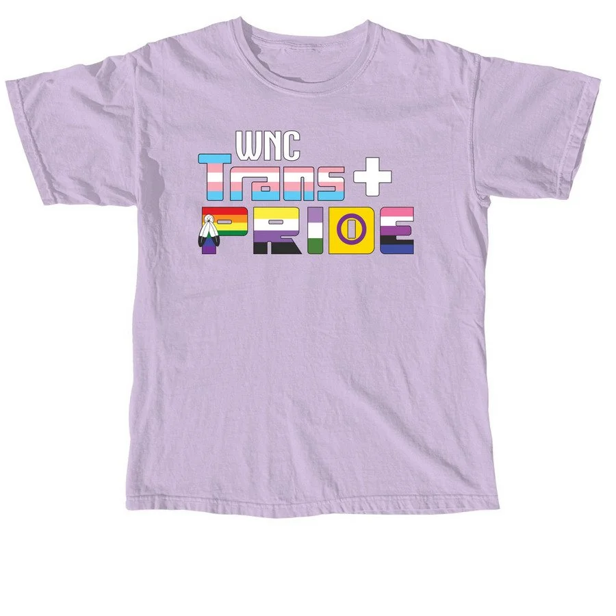 Light purple T-shirt with the text "UNC Trans+ Pride" in colorful, block-style letters, and a small graphic of a person with a transgender flag.