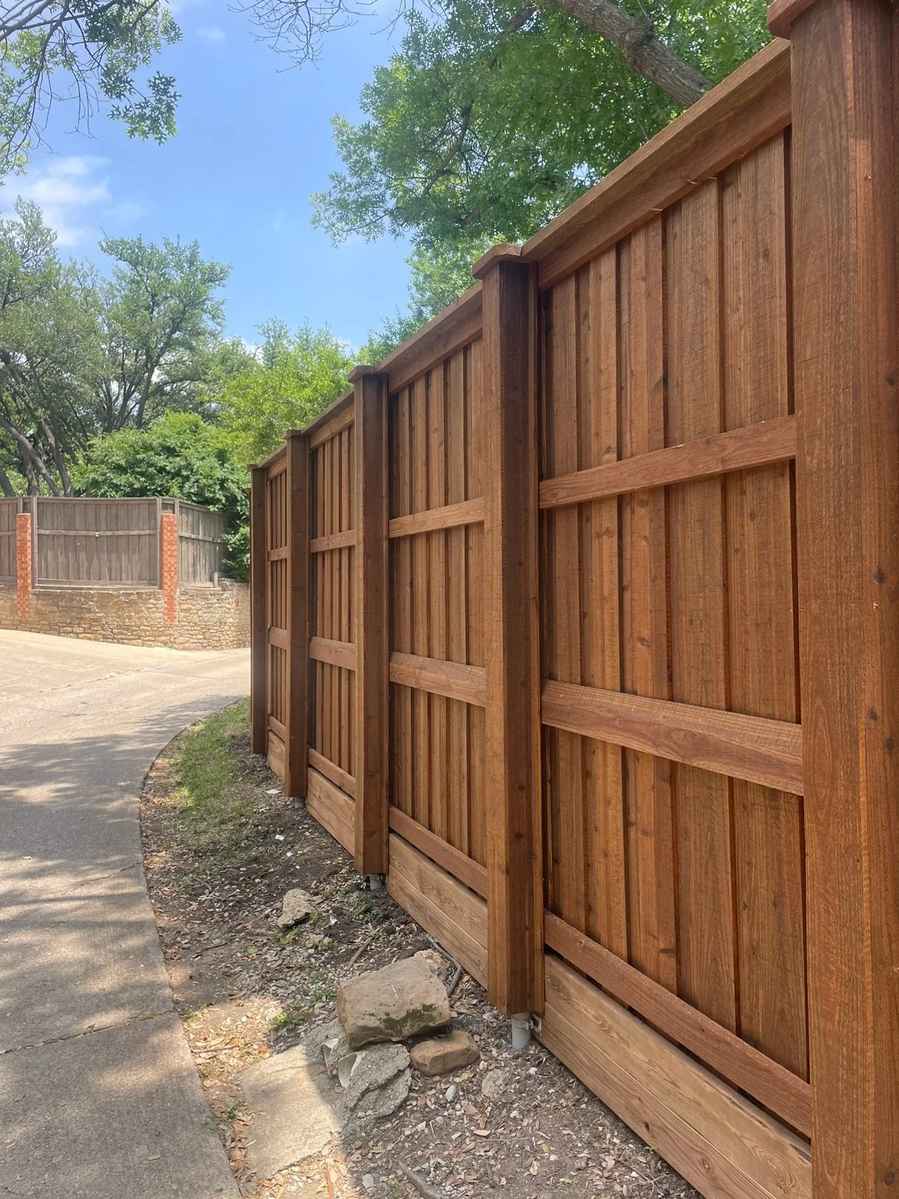 Style: Board on board; Prestain wood with double trim and boxed post