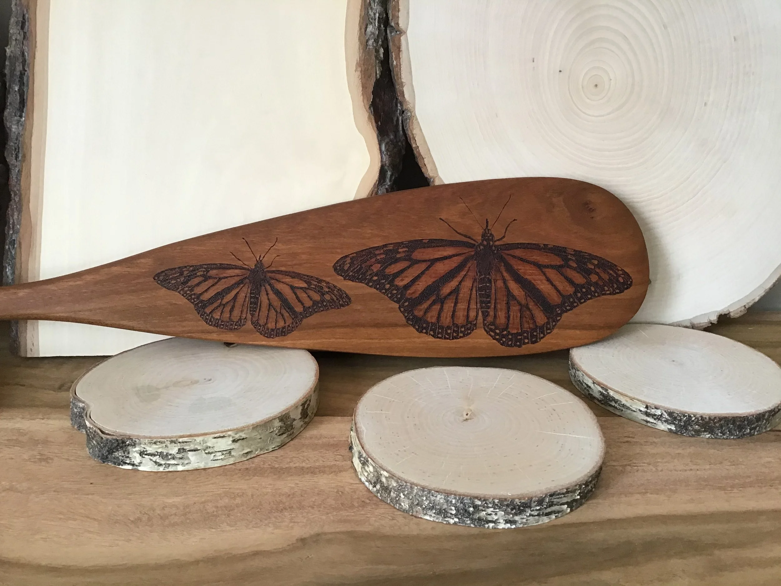 monarch butterfly on wooden paddle