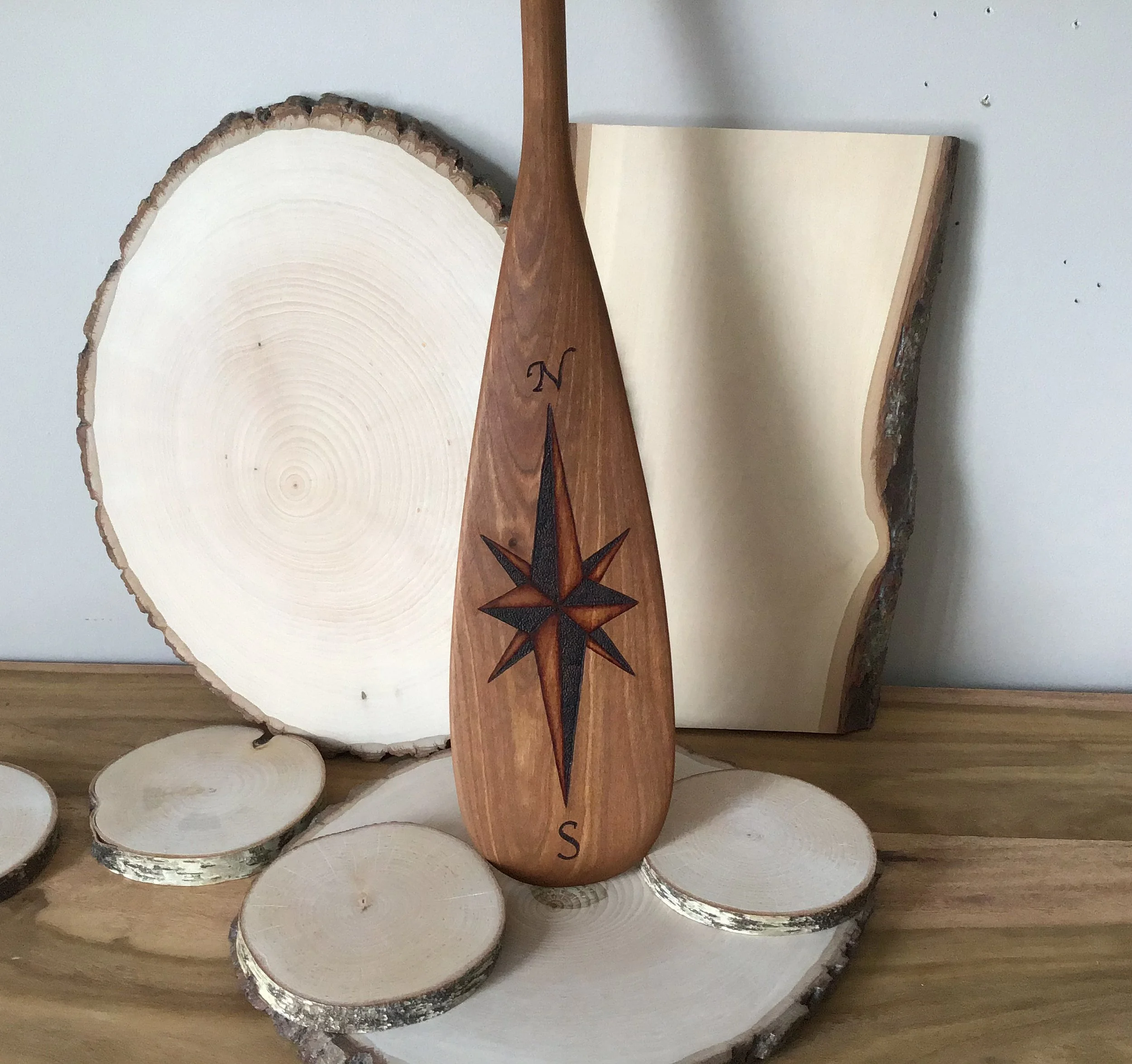 Compass rose on wooden paddle