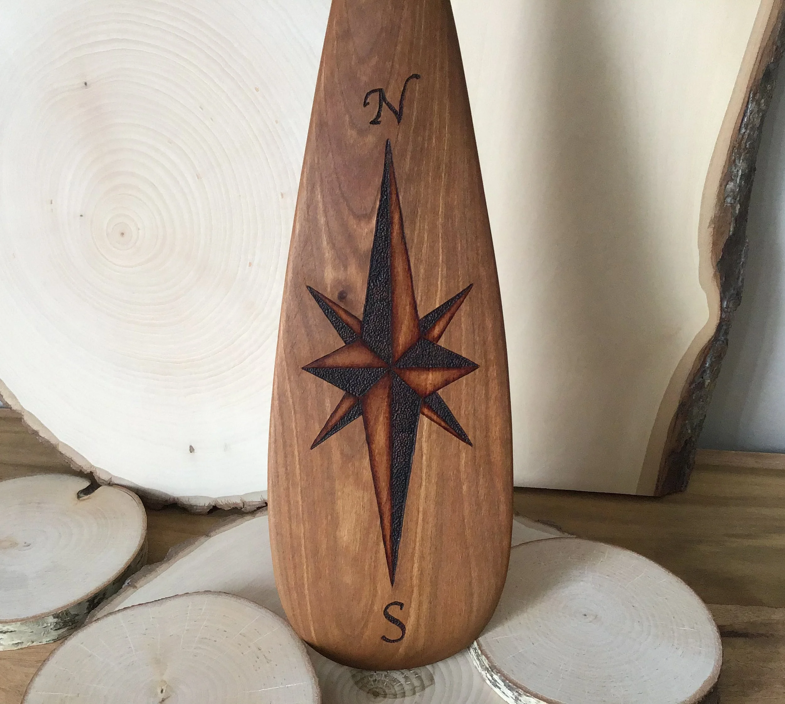 Compass rose on wooden paddle