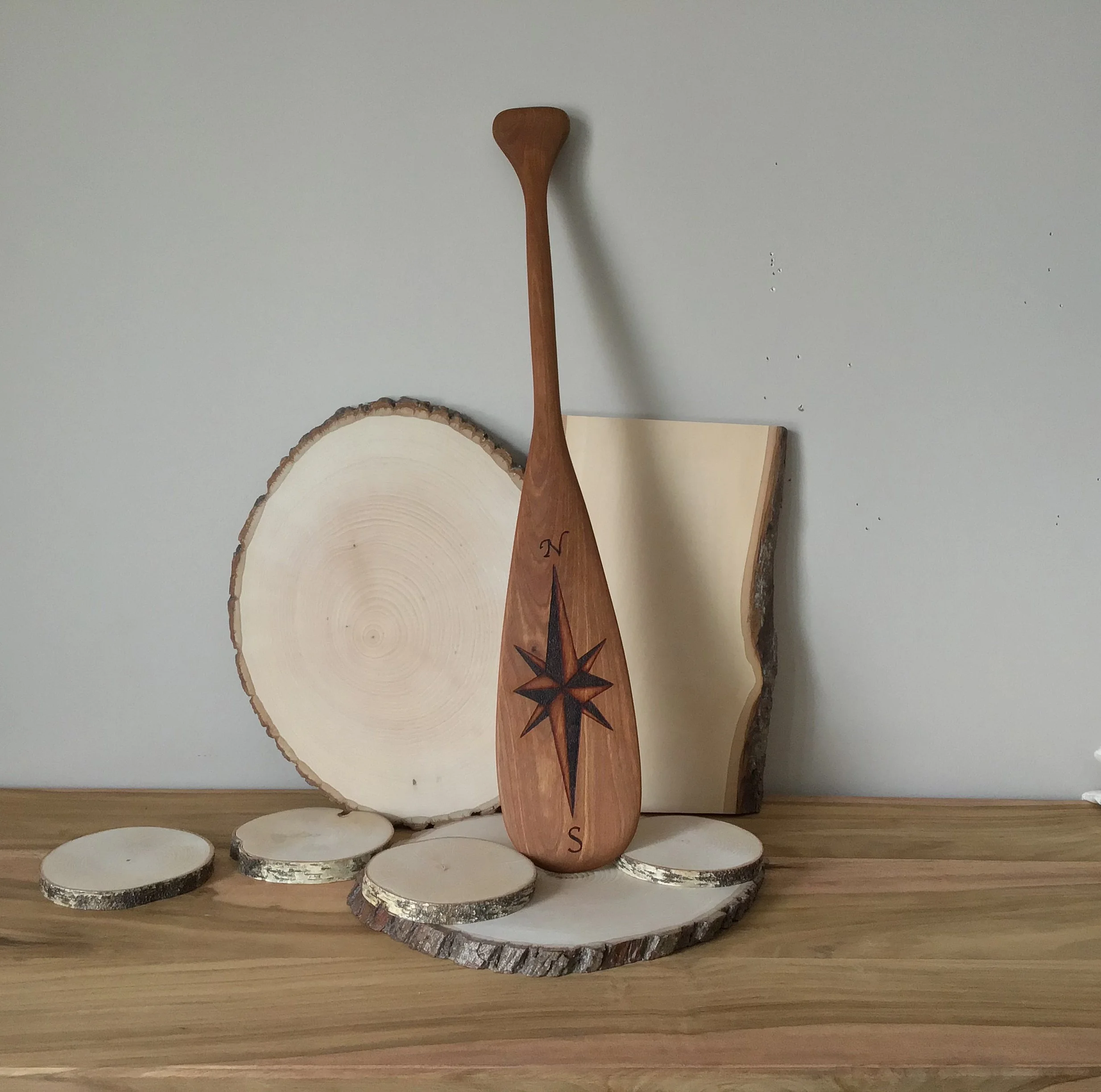 Compass rose on wooden paddle